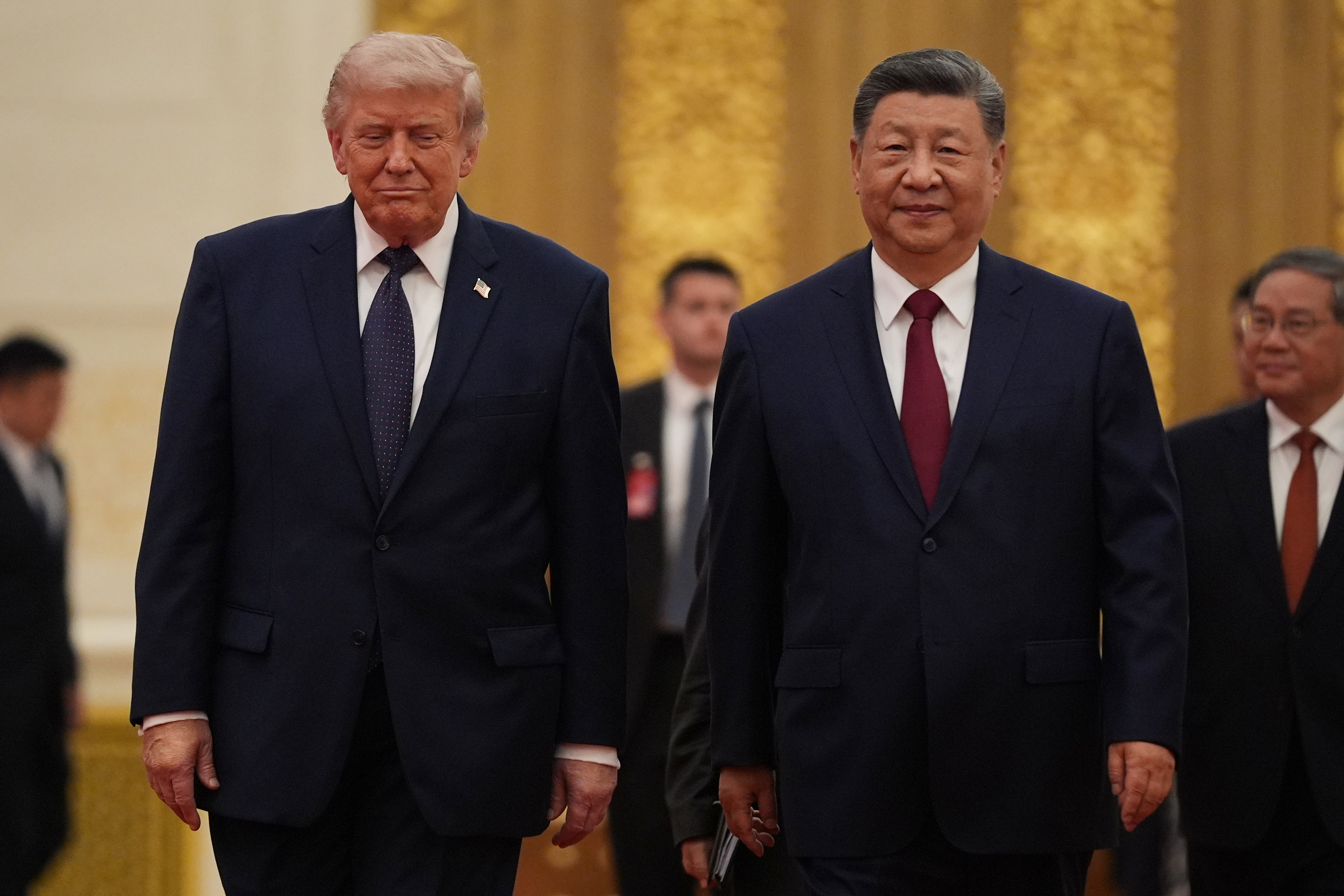President Donald Trump, left, and Chinese President Xi Jinping arrive for a state dinner at the Great Hall of the People on Thursday May 14, 2026, in Beijing. (AP Photo/Mark Schiefelbein)