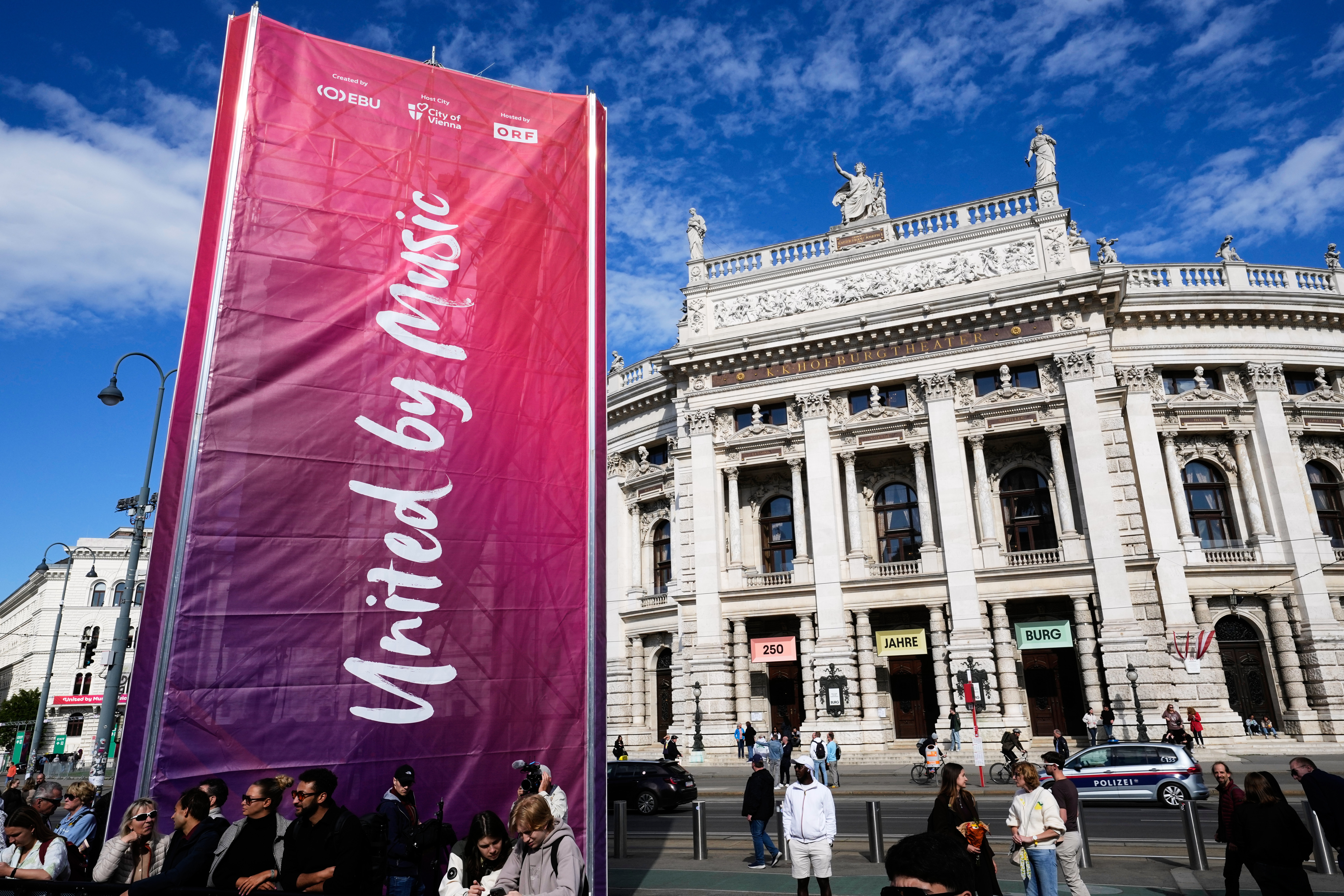 A "United by Music" flag is pictured at the entrance of the Eurovision Village in front of the Burgtheater during the 70th Eurovision Song Contest week in Vienna, Austria, Wednesday, May 13, 2026. (AP Photo/Martin Meissner)