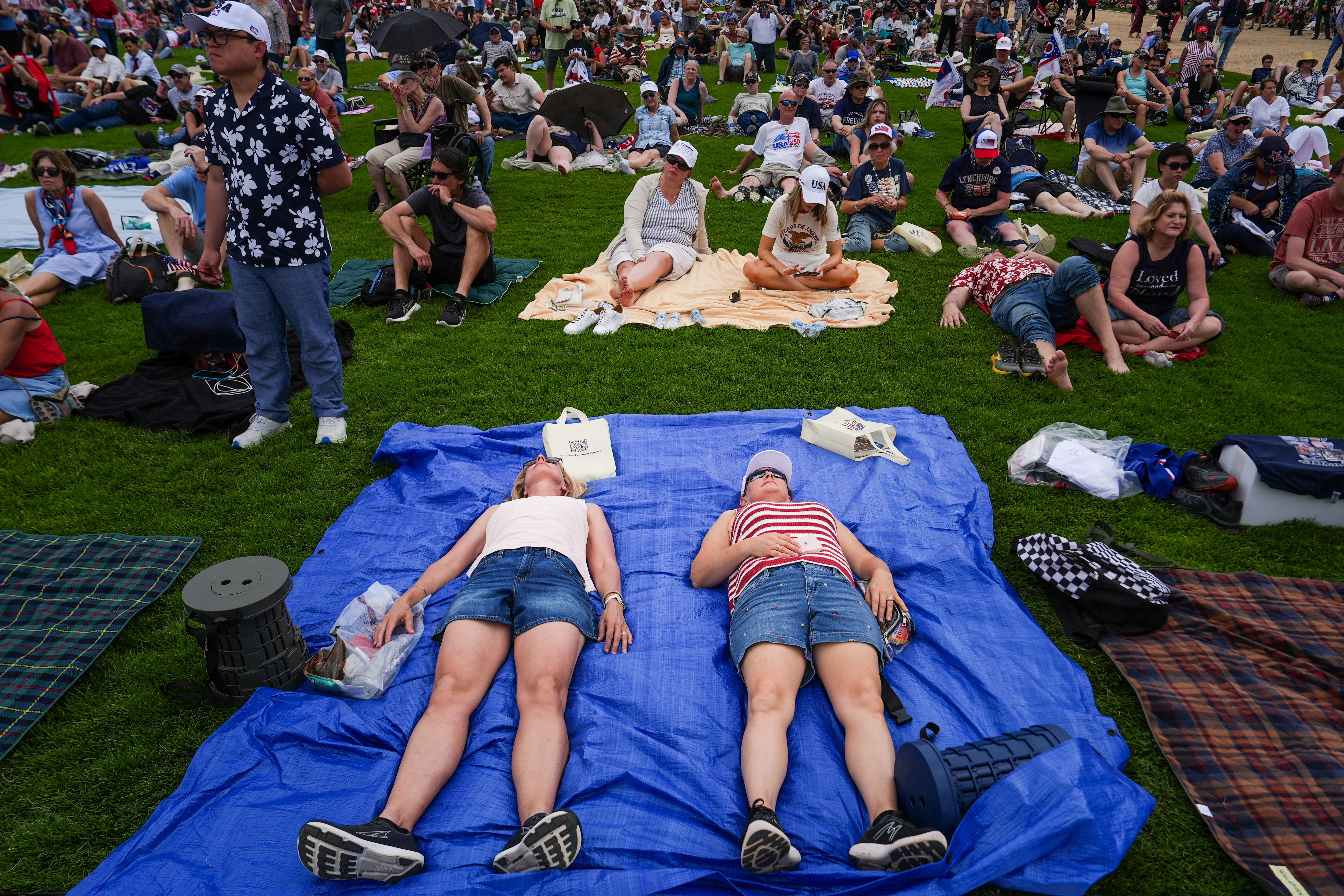 People lay down on the National Mall during Rededicate 250, a mostly conservative Christian prayer gathering in honor of the United States' 250th anniversary, Sunday, May 17, 2026, in Washington. (AP Photo/Julia Demaree Nikhinson)