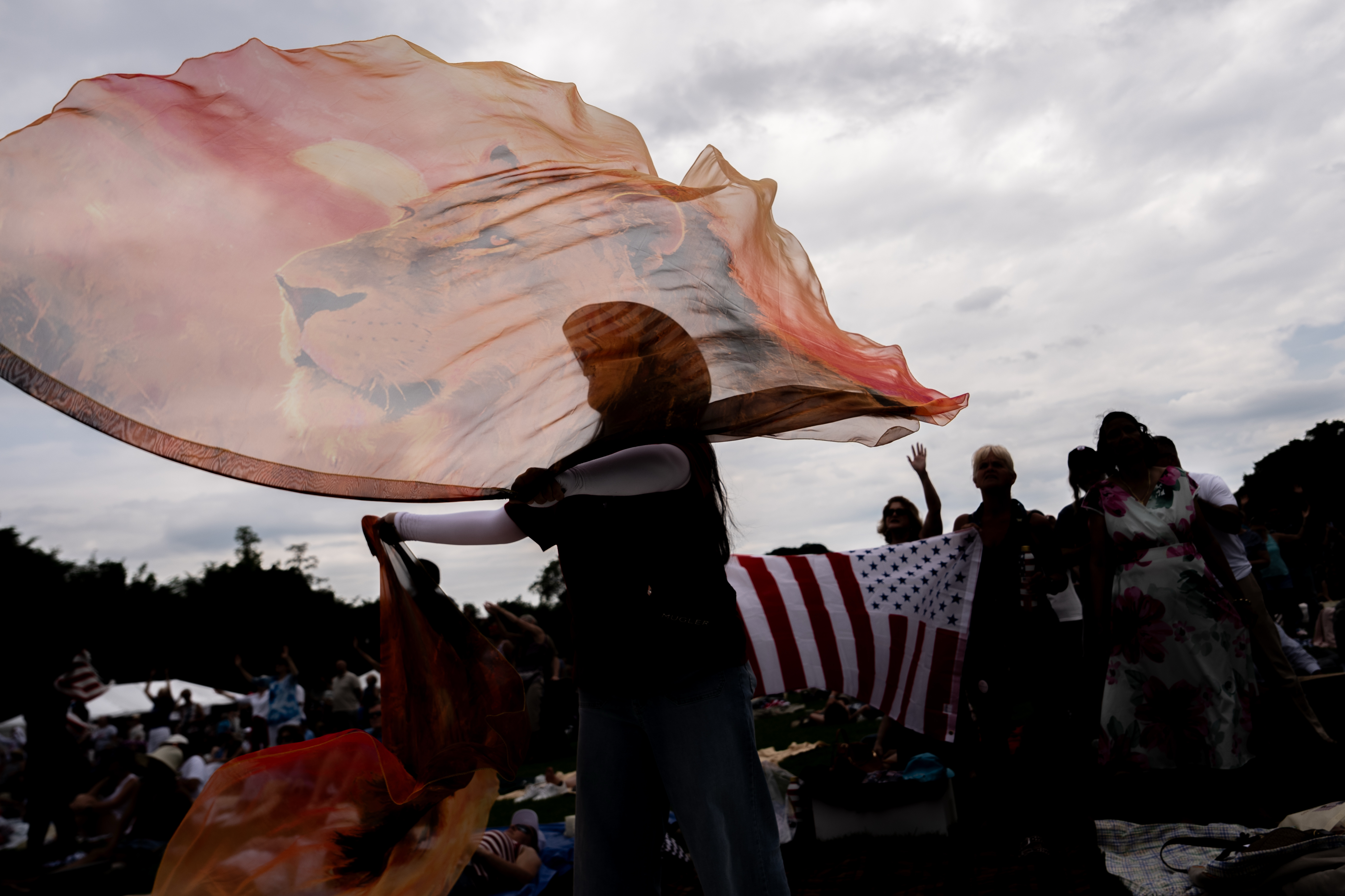 A person twirls Lion of Judah flags as Christian music plays during Rededicate 250, a mostly conservative Christian prayer gathering in honor of the United States' 250th anniversary, on the National Mall, Sunday, May 17, 2026, in Washington. (AP Photo/Julia Demaree Nikhinson)