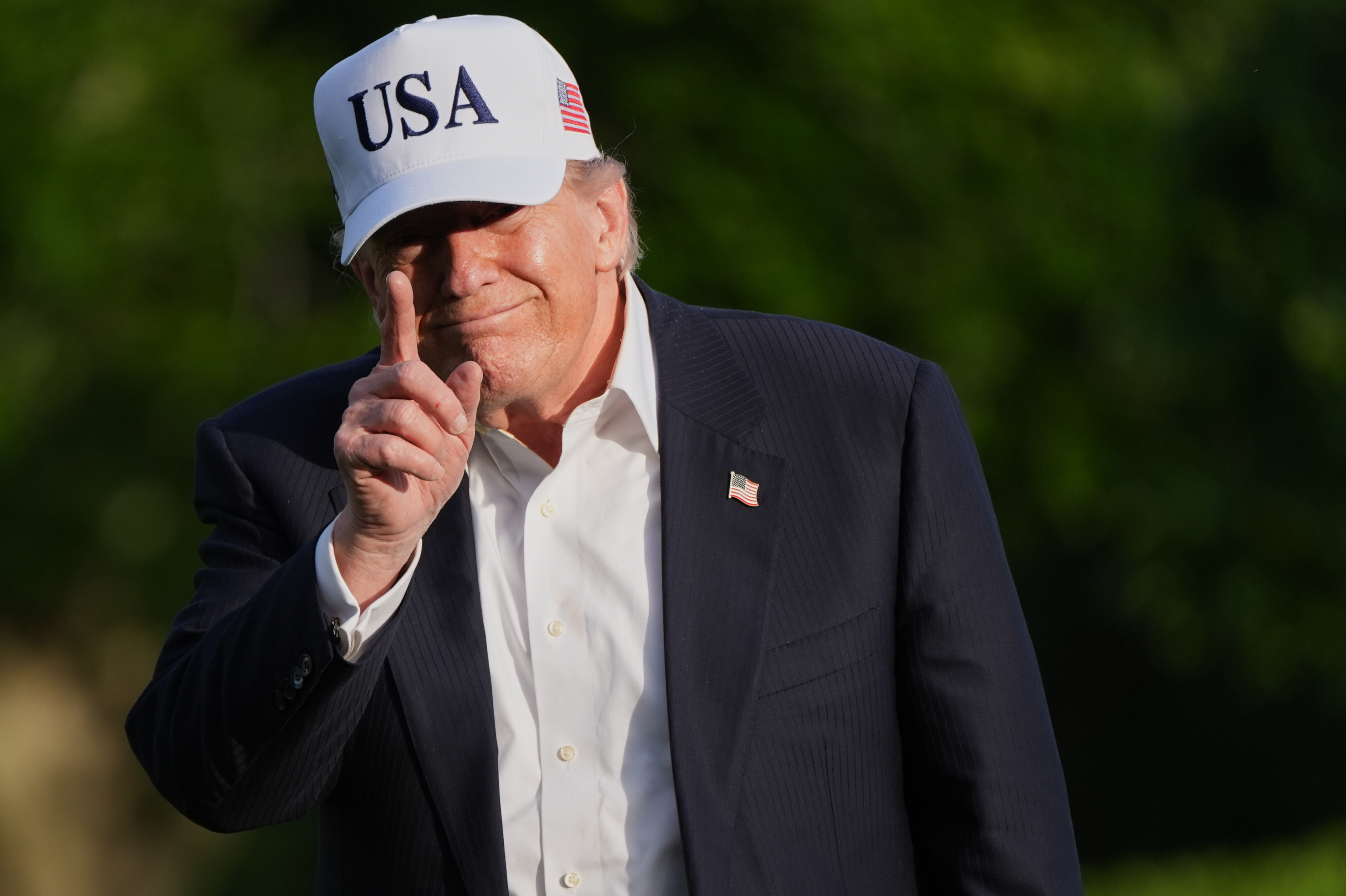 President Donald Trump gestures to reporters as he walks across the South Lawn of the White House, Friday, May 15, 2026, in Washington, on return from Beijing where he met with China's President Xi Jinping. (AP Photo/Jacquelyn Martin)