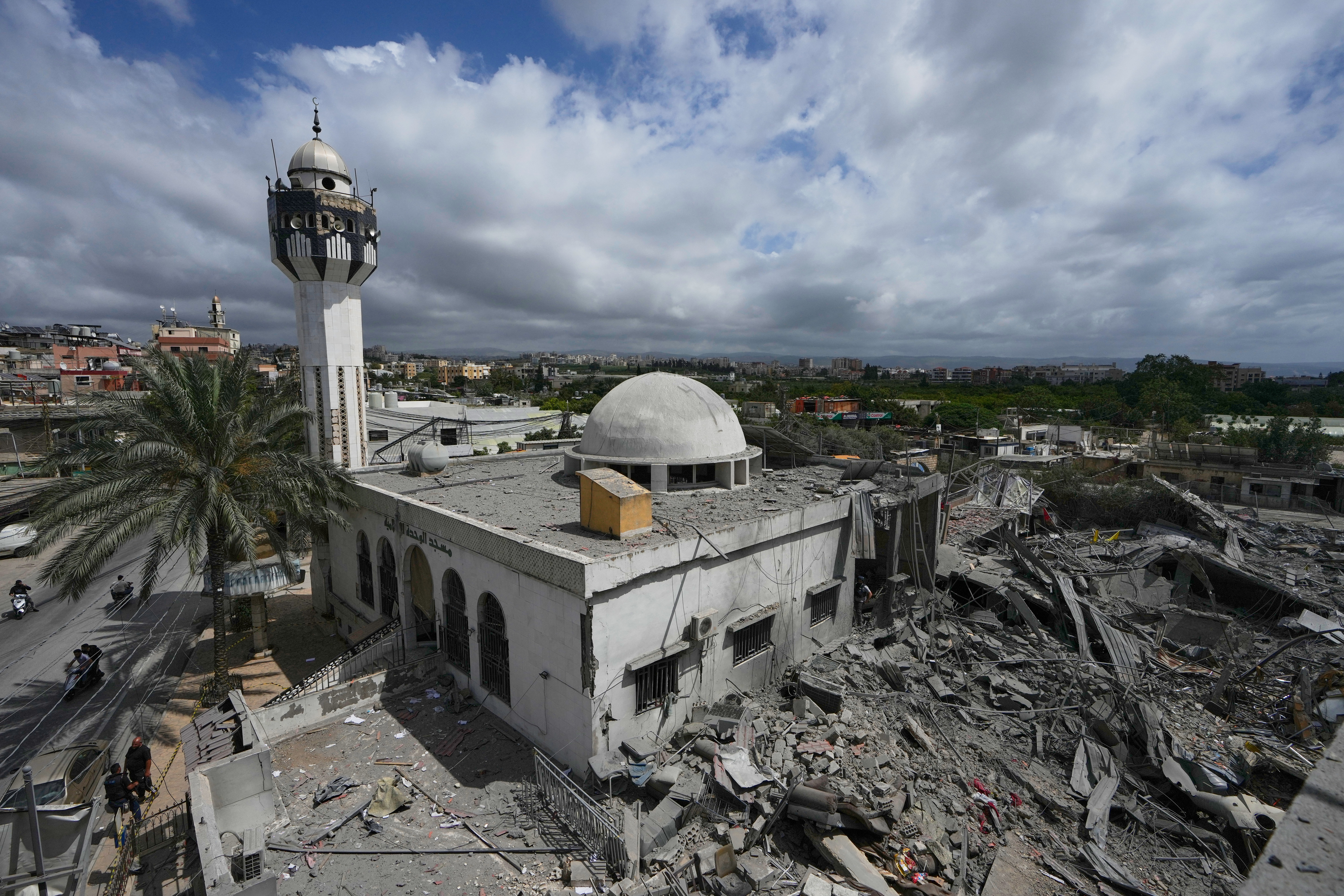 A damaged mosque is seen next of the destroyed Hezbollah paramedic center, right, which was hit in an Israeli airstrike on Tuesday in the village of Maashouk, southern Lebanon, Wednesday, May 20, 2026. (AP Photo/Mohammed Zaatari)