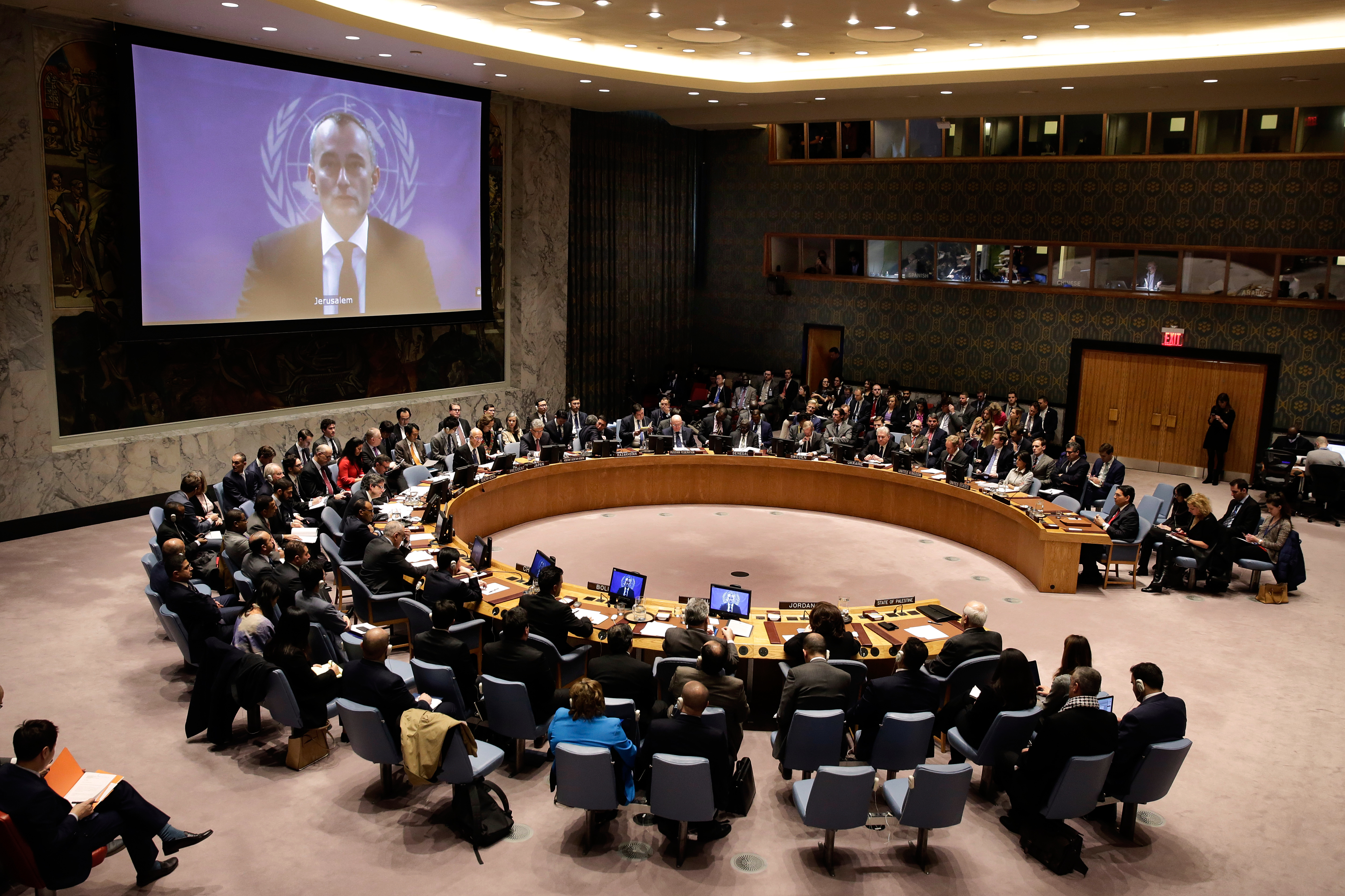 FILE - United Nations Special Coordinator for the Middle East Peace Process Nikolay Mladenov, on screen, addresses the Security Council from Jerusalem, at United Nations headquarters, Dec. 8, 2017. (AP Photo/Richard Drew, File)
