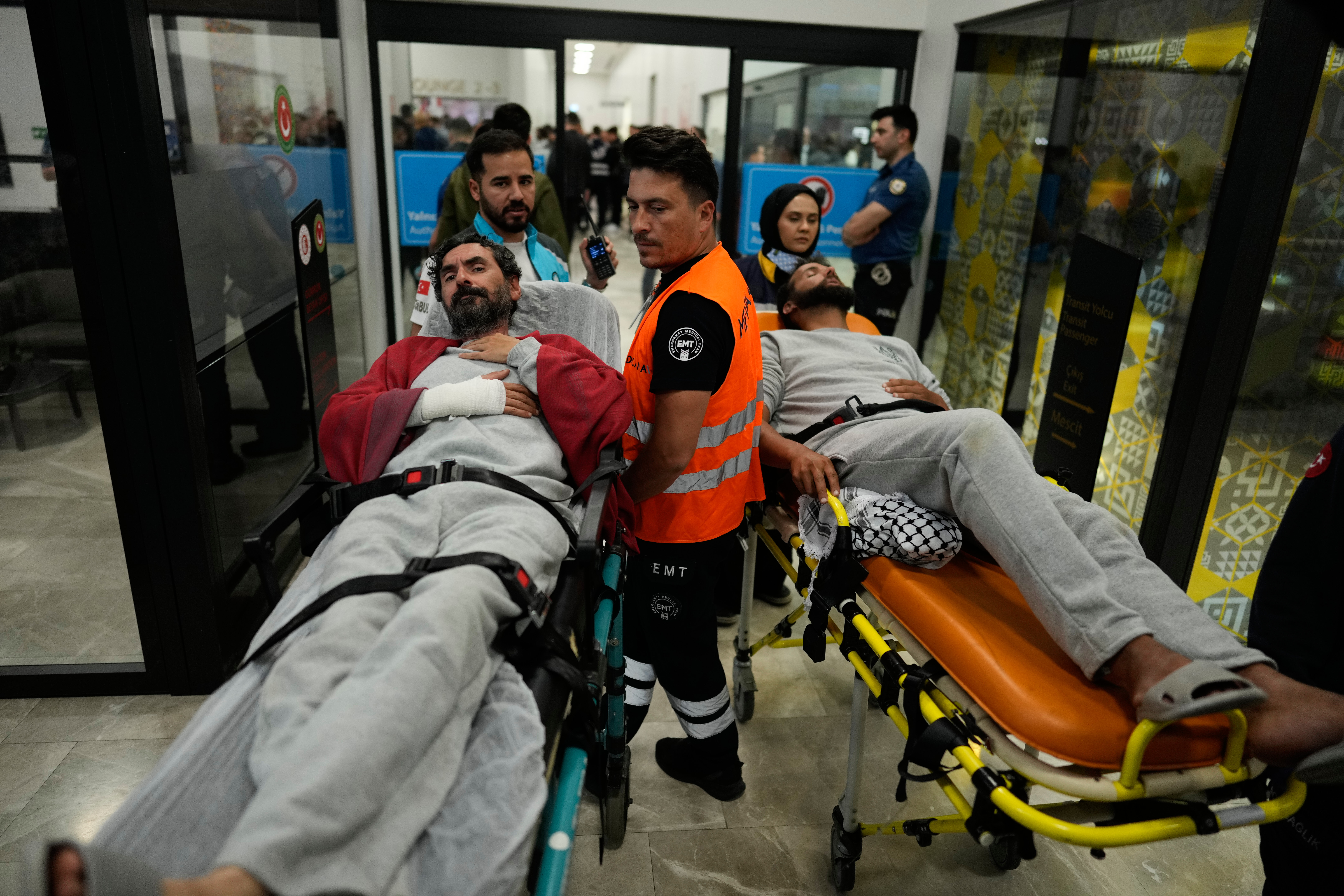 Activists from the Global Sumud Flotilla are carried on wheel stretchers upon their arrival at Istanbul Airport, in Istanbul, Turkey