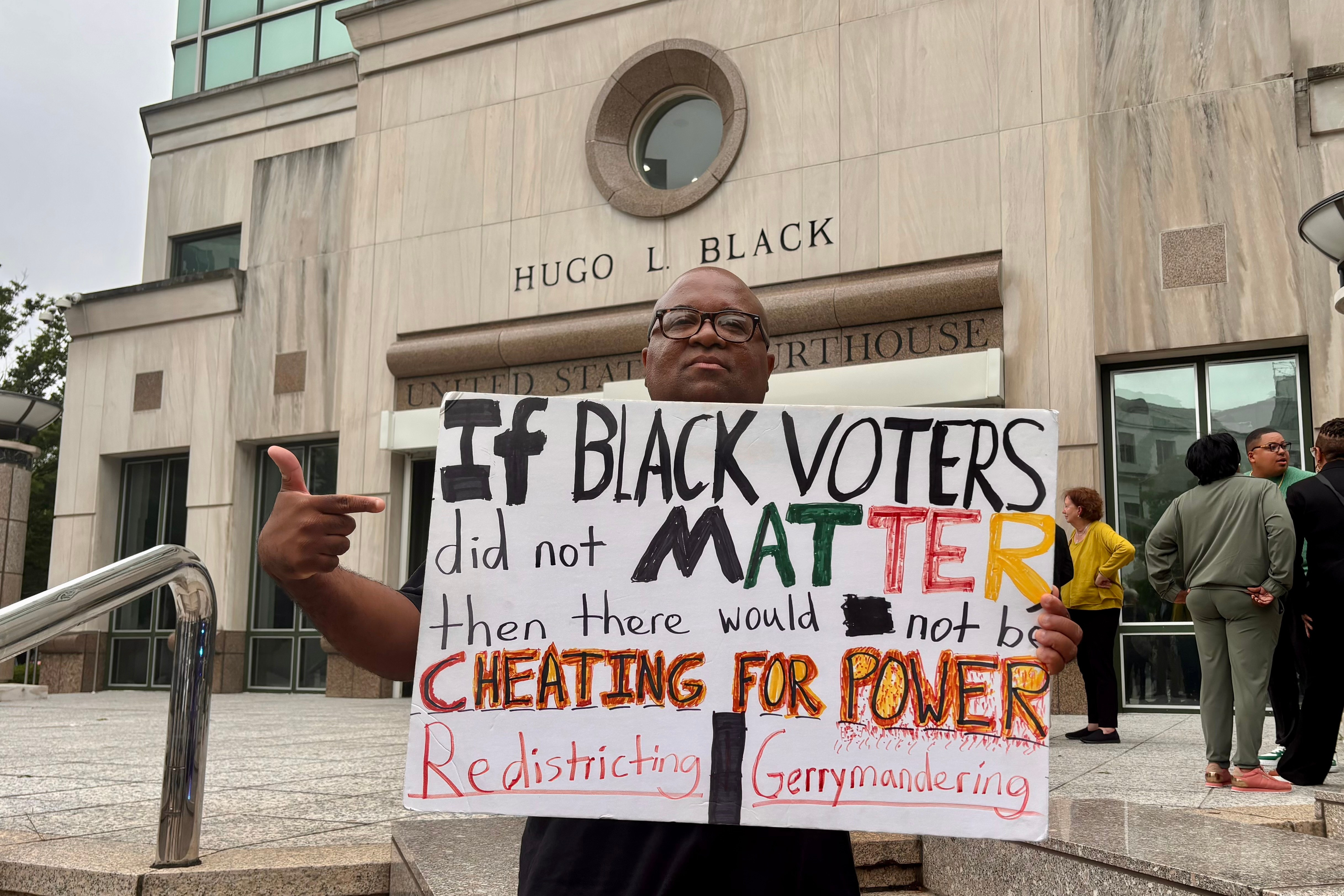 Travis Jackson stands outside the federal courthouse on Friday, May 22, 2026, in Birmingham, Ala. after a court hearing related to redistricting litigation. (AP Photo/Kim Chandler)