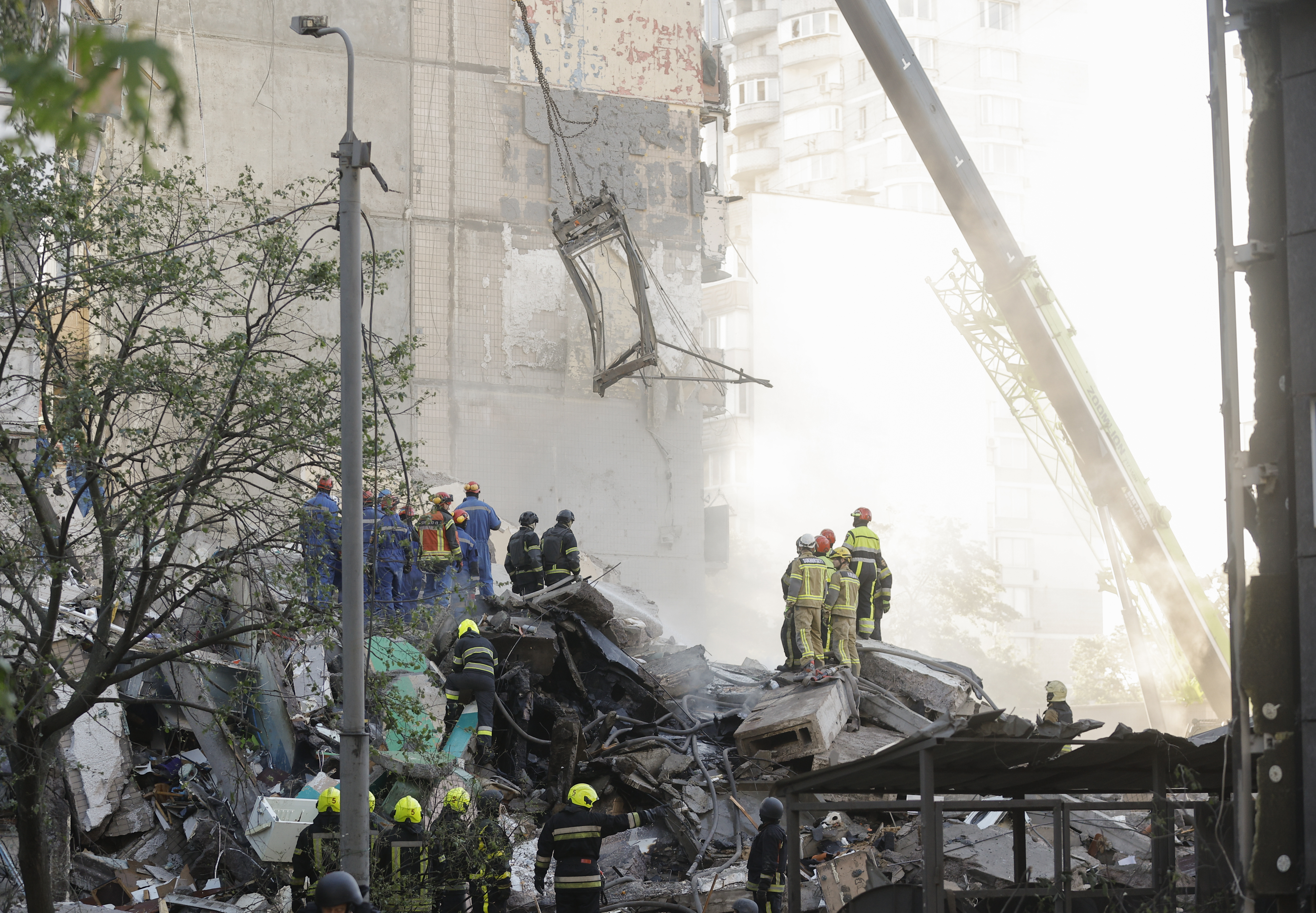 epa12956155 Ukrainian rescuers work at the site of a Russian strike on the nine-storey residential building in Kyiv, Ukraine, 14 May 2026, amid the Russian invasion. At least three people were killed, and ten people are missing, dozens of others (including a one-month-old baby) were injured after an overnight combined Russian attack with drones and missiles hit the Ukrainian capital, according to the State Emergency Service of Ukraine. EPA/SERGEY DOLZHENKO