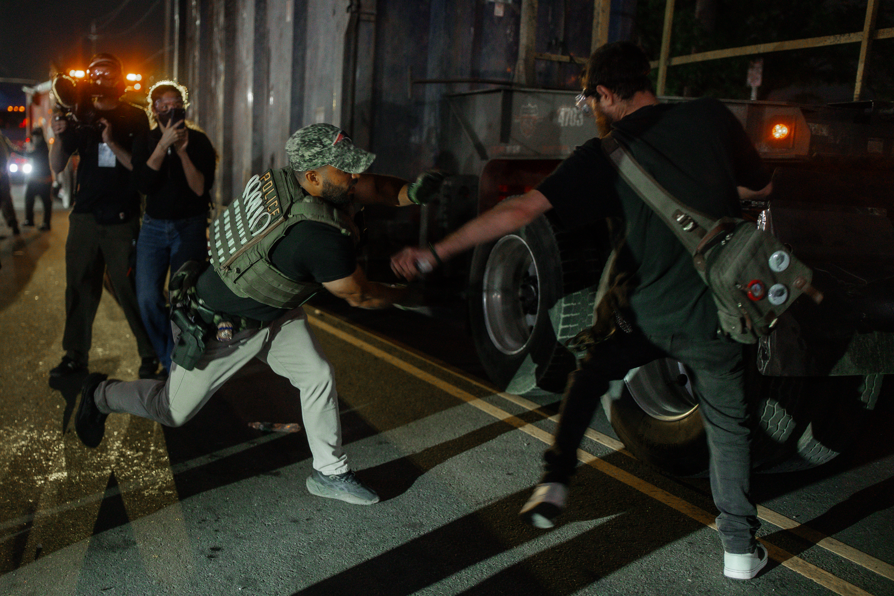 epa12999394 An Immigration and Customs Enforcement (ICE) agent chases a protester on the road where he nearly gets hit by a truck during a protest against the treatment of detainees at the Delaney Hall Detention Facility in Newark, New Jersey, USA, 27 May 2026 (issued 28 May 2026). About 300 detainees at the Delaney Hall immigration facility center signed a letter, beginning a hunger strike over detention conditions since 22 May. EPA/OLGA FEDOROVA