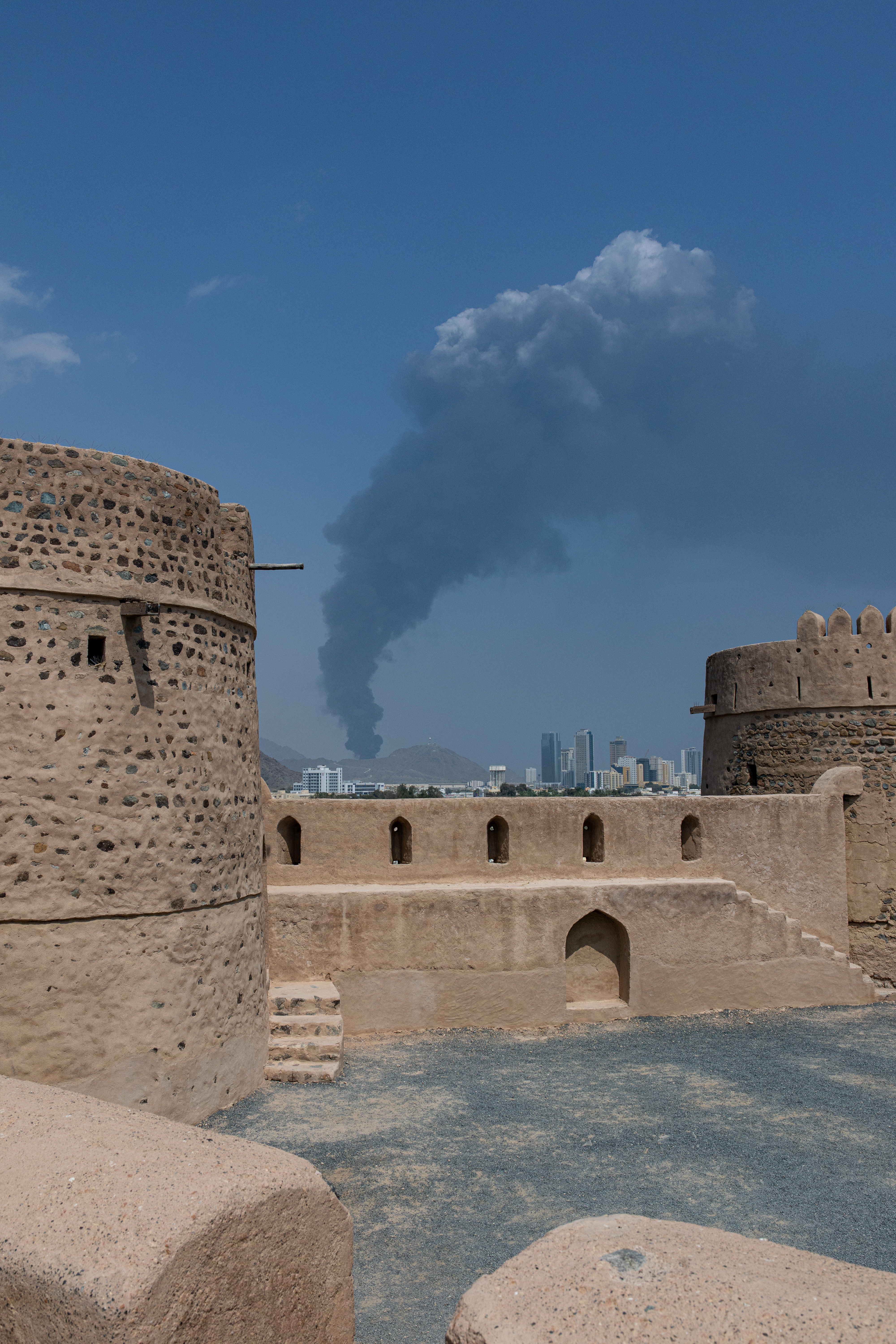 FUJAIRAH, UNITED ARAB EMIRATES - MARCH 05: Smoke rises after an explosion in the industrial zone, caused by debris after interception of a drone by air defence, according to the Fujairah media office on March 05, 2026, in Fujairah, United Arab Emirates. In recent days, Iran has fired drones and missiles toward the UAE and other Gulf states, following the joint U.S.-Israeli attack on Iran that began on February 28. Foreign ministers from the Gulf Co-operation Council (GCC) held an online meeting on March 1 and issued a statement saying they will take "all necessary measures" to defend their security and territory, condemning Iran's attacks as "heinous." (Photo by Christopher Pike/Getty Images)