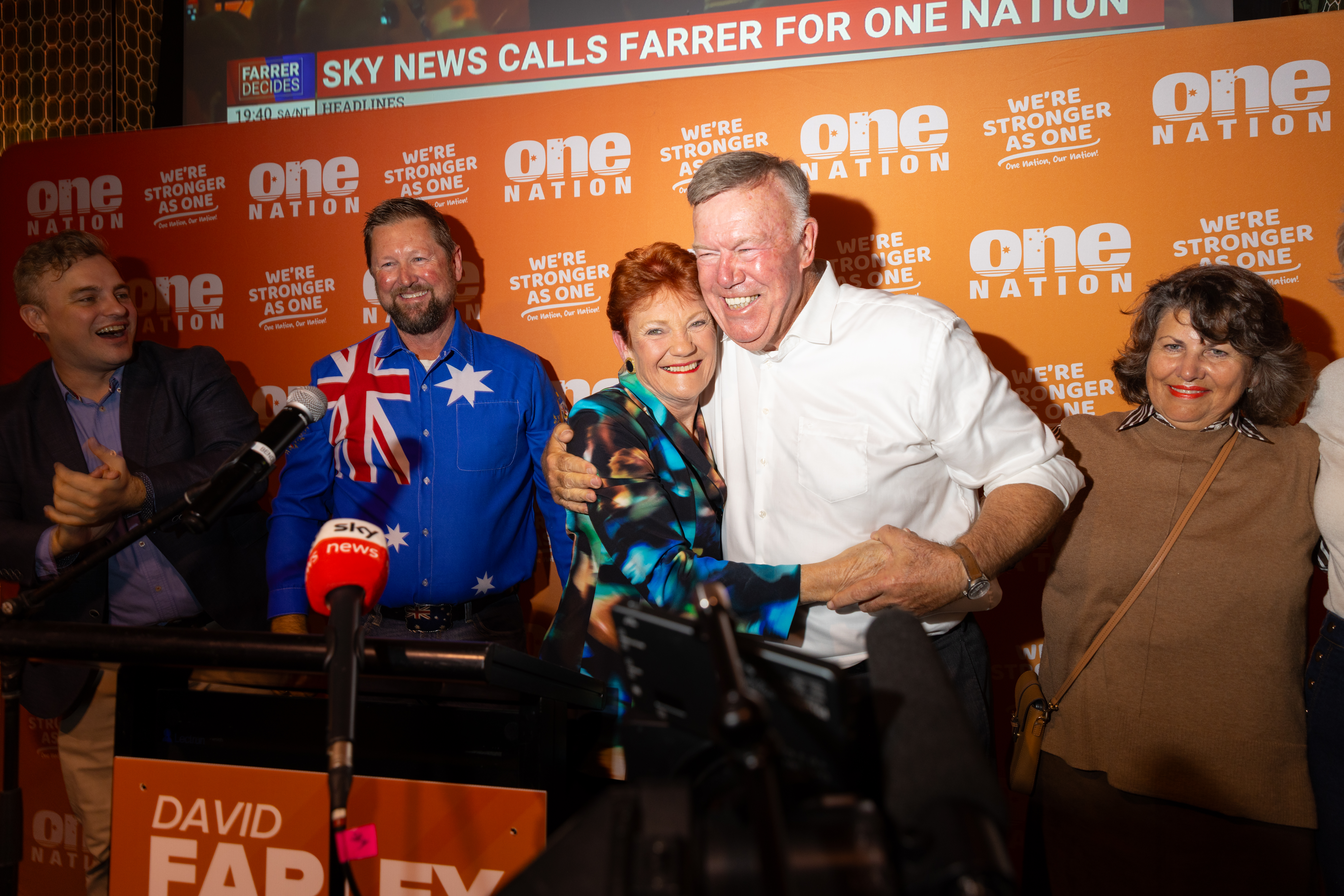 ALBURY, AUSTRALIA - MAY 09: One Nation leader, Pauline Hanson, and winning candidate, David Farley, embrace as their party wins the Farrer by-election on May 9, 2026 in Albury, Australia. The May 9 contest, triggered by Sussan Ley's resignation after being ousted as Liberal leader by Angus Taylor in February, has since evolved into a rare four-cornered race between the Liberals, the Nationals, an independent and One Nation — with polling suggesting the minor party could secure as much as 29 percent of the primary vote in the sprawling rural electorate. (Photo by Jesse Thompson/Getty Images)