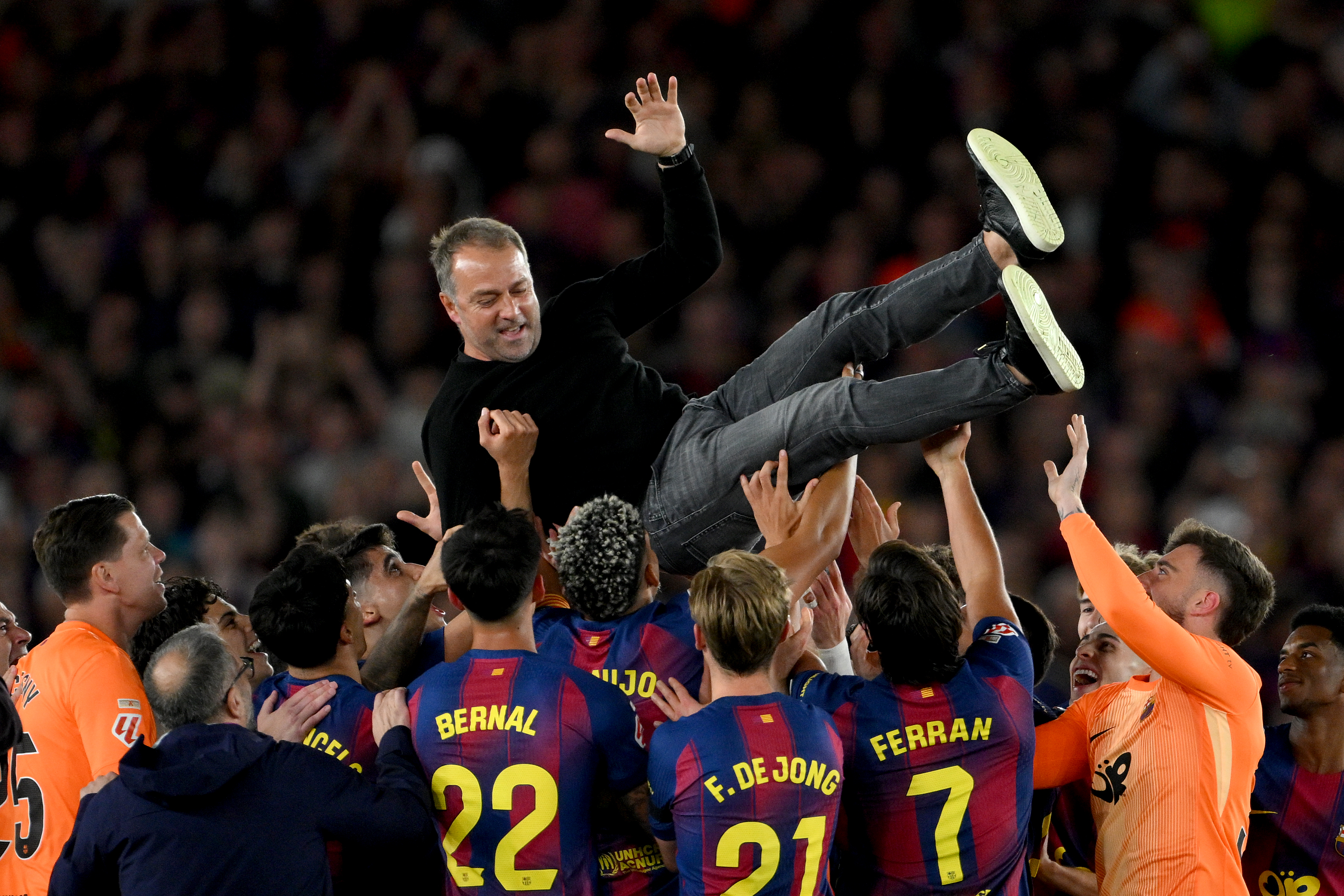 BARCELONA, SPAIN - MAY 10: Hansi Flick, Head Coach of FC Barcelona, is thrown in the air by players of FC Barcelona as they celebrate after defeating Real Madrid, and winning the LaLiga title, after the LaLiga EA Sports match between FC Barcelona and Real Madrid CF at Spotify Camp Nou on May 10, 2026 in Barcelona, Spain. (Photo by David Ramos/Getty Images)