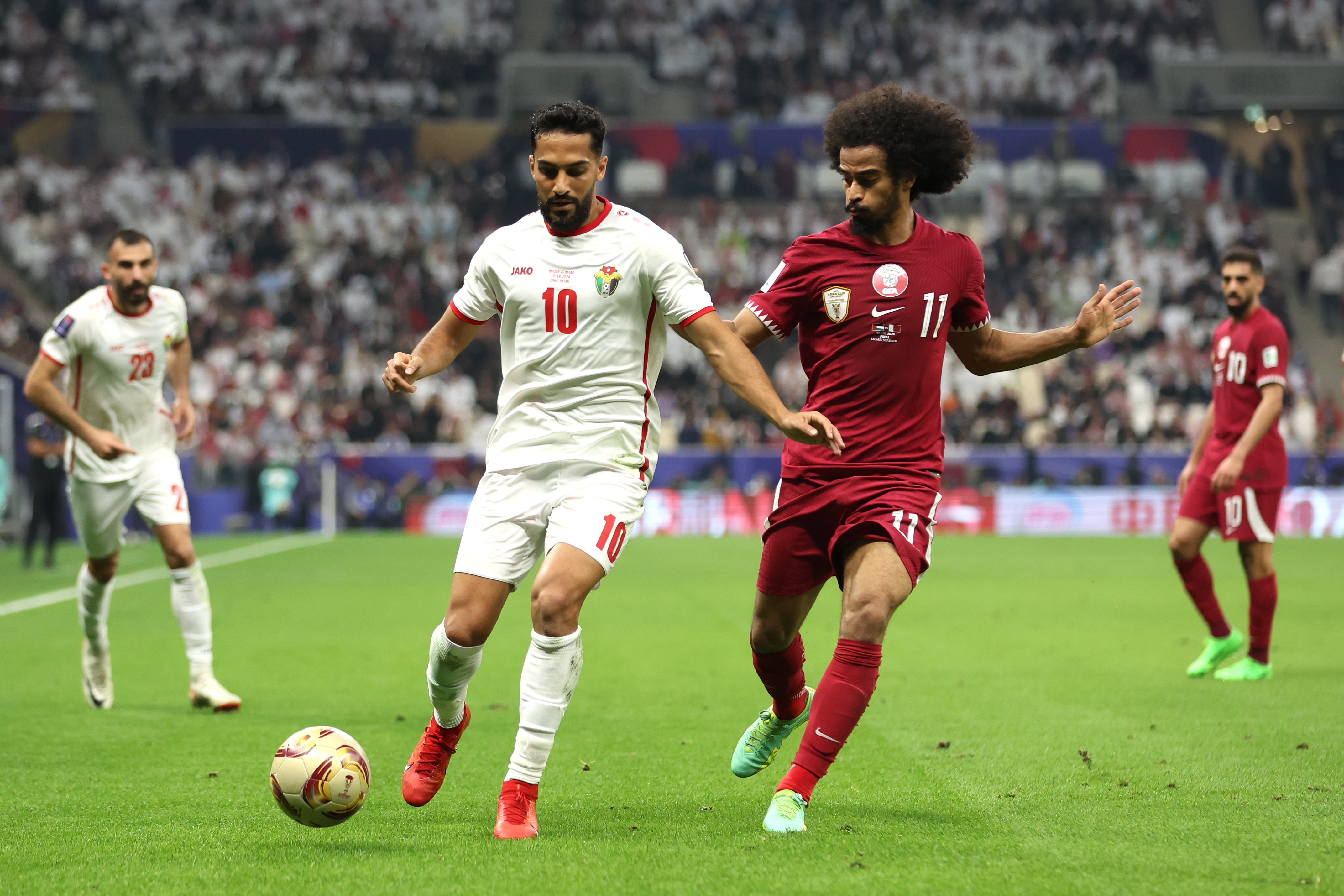LUSAIL CITY, QATAR - FEBRUARY 10: Musa Al-Taamari of Jordan battles for possession with Akram Afif of Qatar during the AFC Asian Cup final match between Jordan and Qatar at Lusail Stadium on February 10, 2024 in Lusail City, Qatar. (Photo by Robert Cianflone/Getty Images)