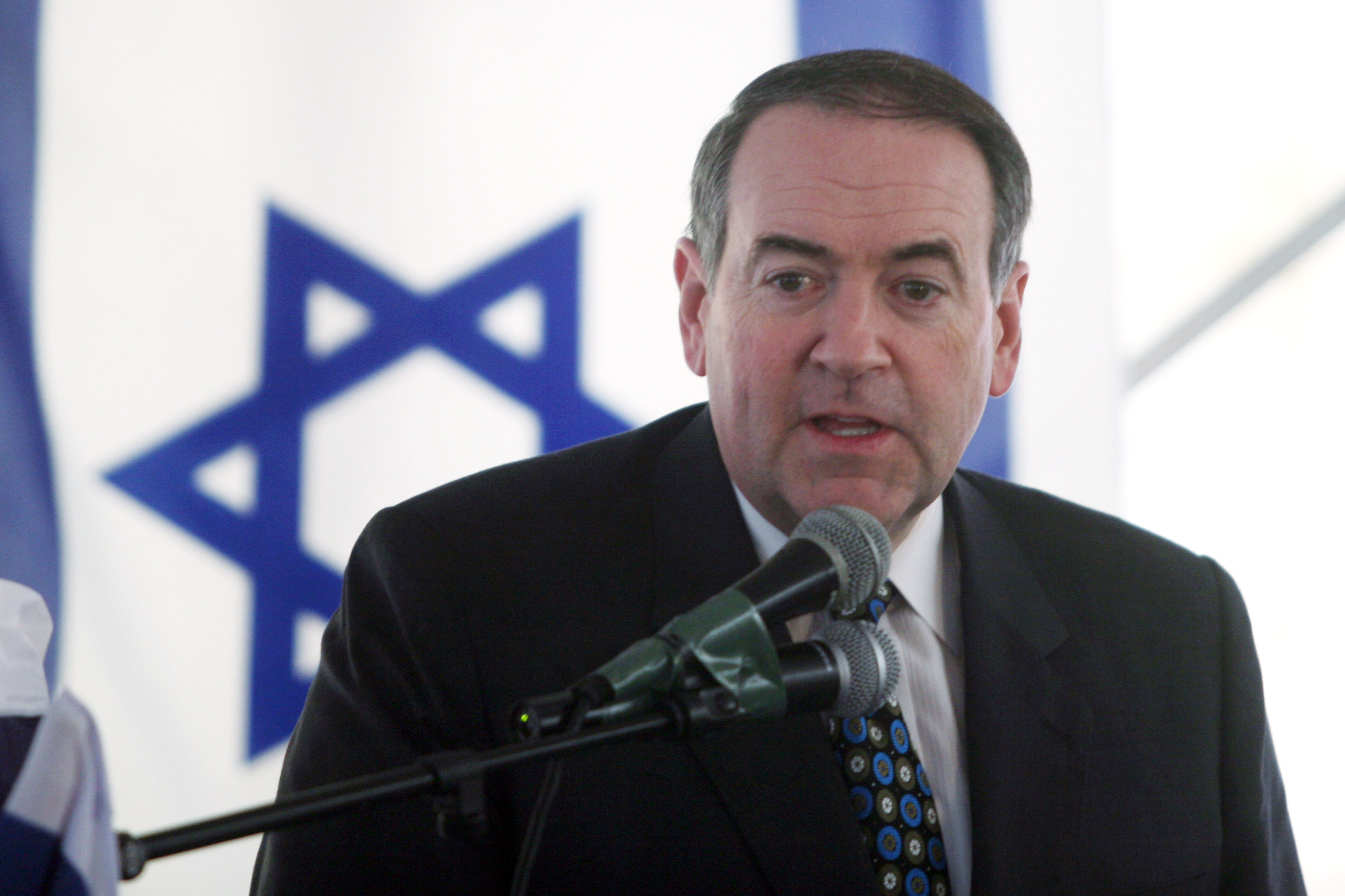 JERUSALEM, ISRAEL - JANUARY 31: (Israel OUT) Former Arkansas Gov. and possible Republican presidential candidate Mike Huckabee (C) speaks during a corner stone dedication ceremony for a new Jewish settlement on January 31, 2011 at Beit Orot, between Mount Scopus and Mount of Olives, in East Jerusalem, Israel. According to reports, Huckabee compared attempts at preventing Jewish settlers to building in east Jerusalem to housing discrimination in the U.S. (Photo by Lior Mizrahi /Getty Images)