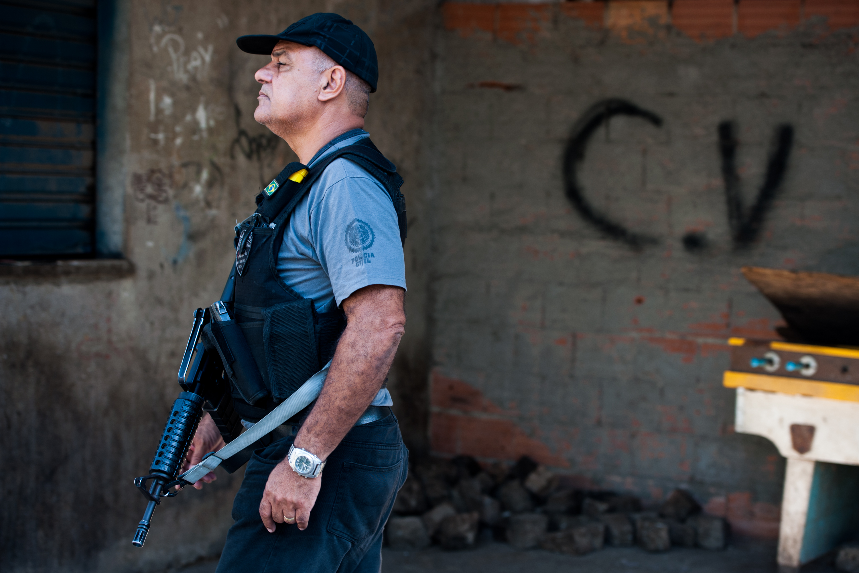 RIO DE JANEIRO, BRAZIL - MARCH 30: A Brazilian military police patrol with the symbol at the bottom of the criminal group Comando Vermelho after entering the unpacified Complexo da Mare, one of the largest 'favela' complexes in Rio, on March 30, 2014 in Rio de Janeiro, Brazil. The Brazilian government has deployed federal forces to occupy the group of violence-plagued slums ahead of the June 12 start of the 2014 FIFA World Cup. The group of 16 communities house around 130,000 residents and have been dominated by drug gangs and militias. Mare is located close to Rio's international airport and has been mentioned as a likely pacification target for the police amid the city's efforts to improve security ahead of the 2014 FIFA World Cup and Rio 2016 Olympic Games. (Photo by Buda Mendes/Getty Images)