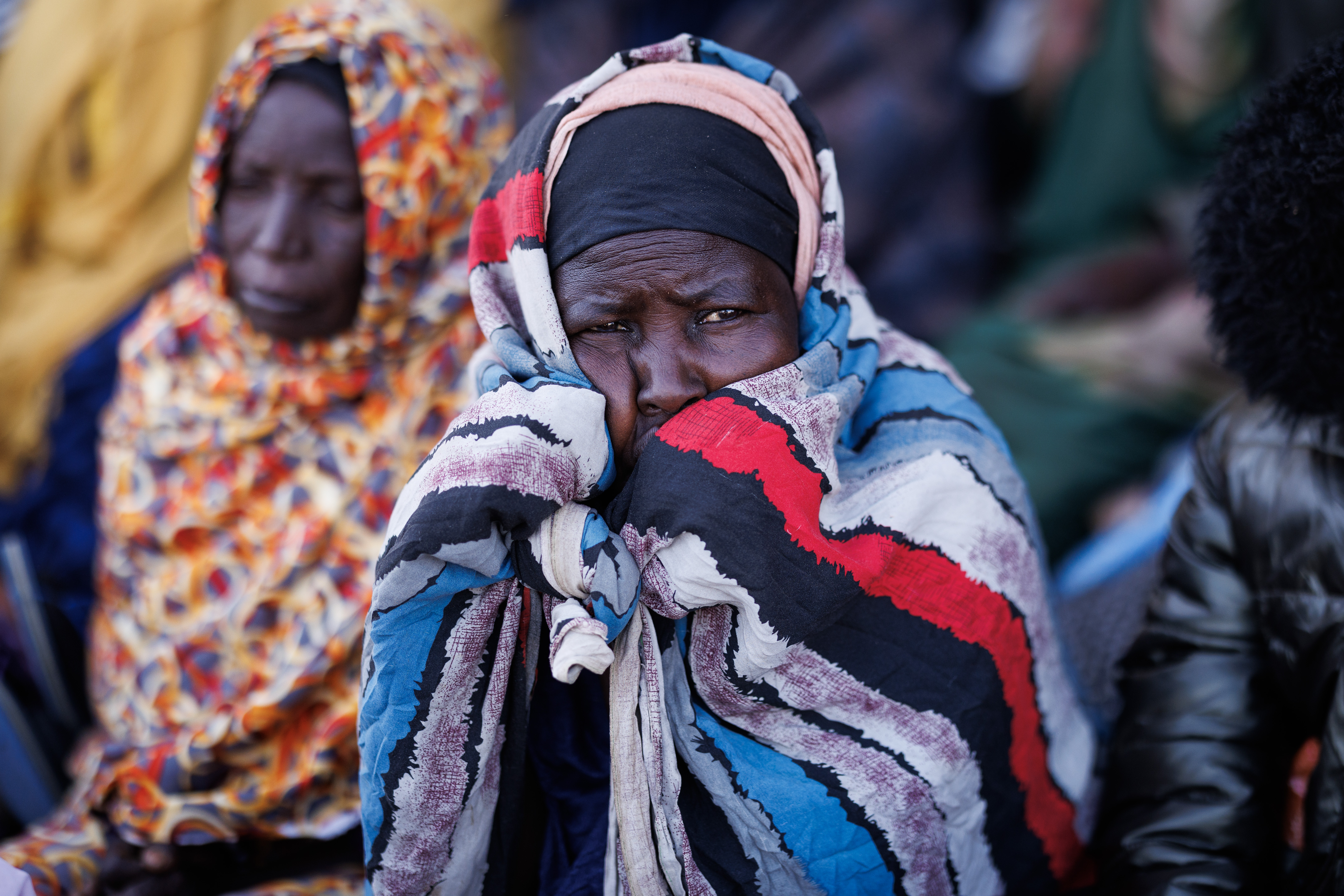 OURE CASSONI, CHAD - FEBRUARY 24: Sudanese refugees wait for registration papers at the Oure Cassoni refugee camp after arriving from Sudan, on February 24, 2026 in Oure Cassoni, Chad. In April 2023 civil war erupted between the Sudanese Armed Forces (SAF) and the armed militia group Rapid Support Forces (RSF). The ongoing conflict has so far displaced around 14 million people across the region, triggering a widespread humanitarian crisis, as neighboring countries like Chad struggle to absorb refugees, while coping with populations already suffering high poverty rates and food insecurity. Chad has become Africa's largest host of refugees per capita, hosting a total 1.4 million refugees - more than 900,000 of which fled the conflict in Sudan. The most recent wave of arrivals from Sudan follows the RSF's offensive to capture the north Darfur city of El Fasher, where 6,000 people were reportedly killed by the RSF in the space of three days in October. A recent UN report has accused the RSF of atrocities that amount to war crimes and possible crimes against humanity. As many as 400,000 people have reportedly been killed since the conflict began. (Photo by Dan Kitwood/Getty Images)