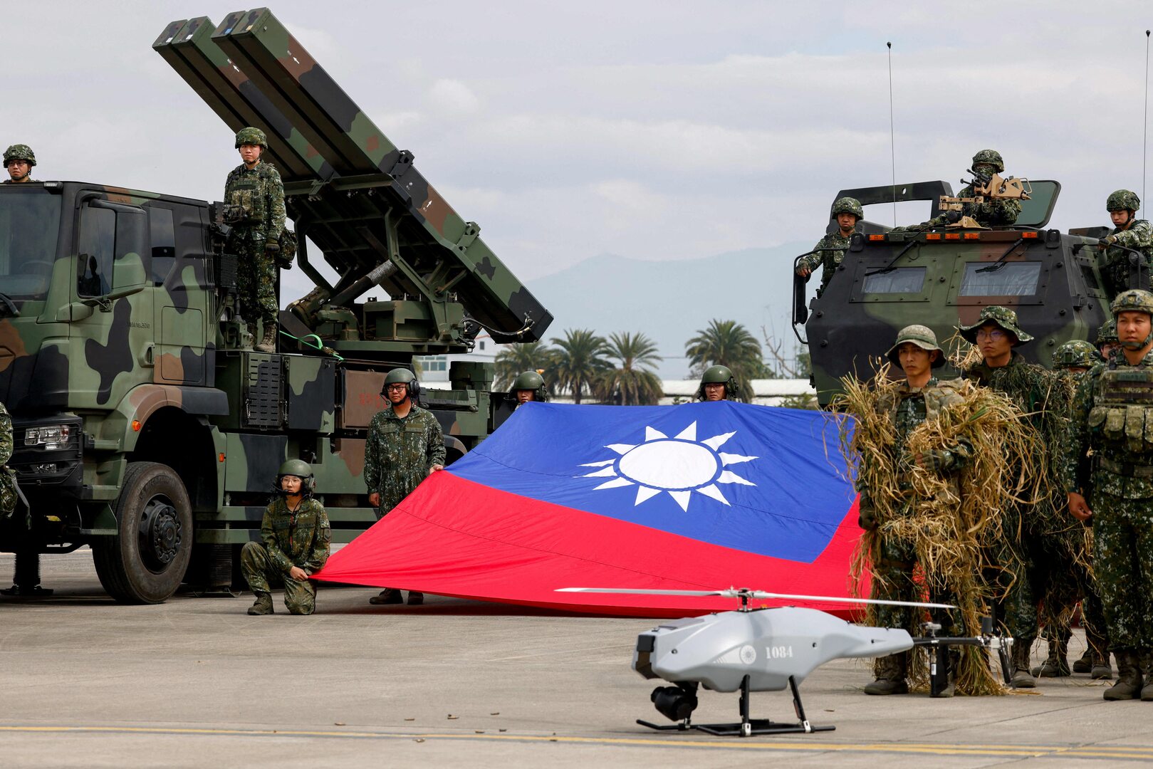 Taiwanese soldiers pose with a Taiwanese flag near a Sky Sword II surface-to-air missile launcher and a military UAV during an annual military exercise ahead of Lunar New Year in Taichung, Taiwan on Jan. 27, 2026. [Ann Wang/Reuters]
