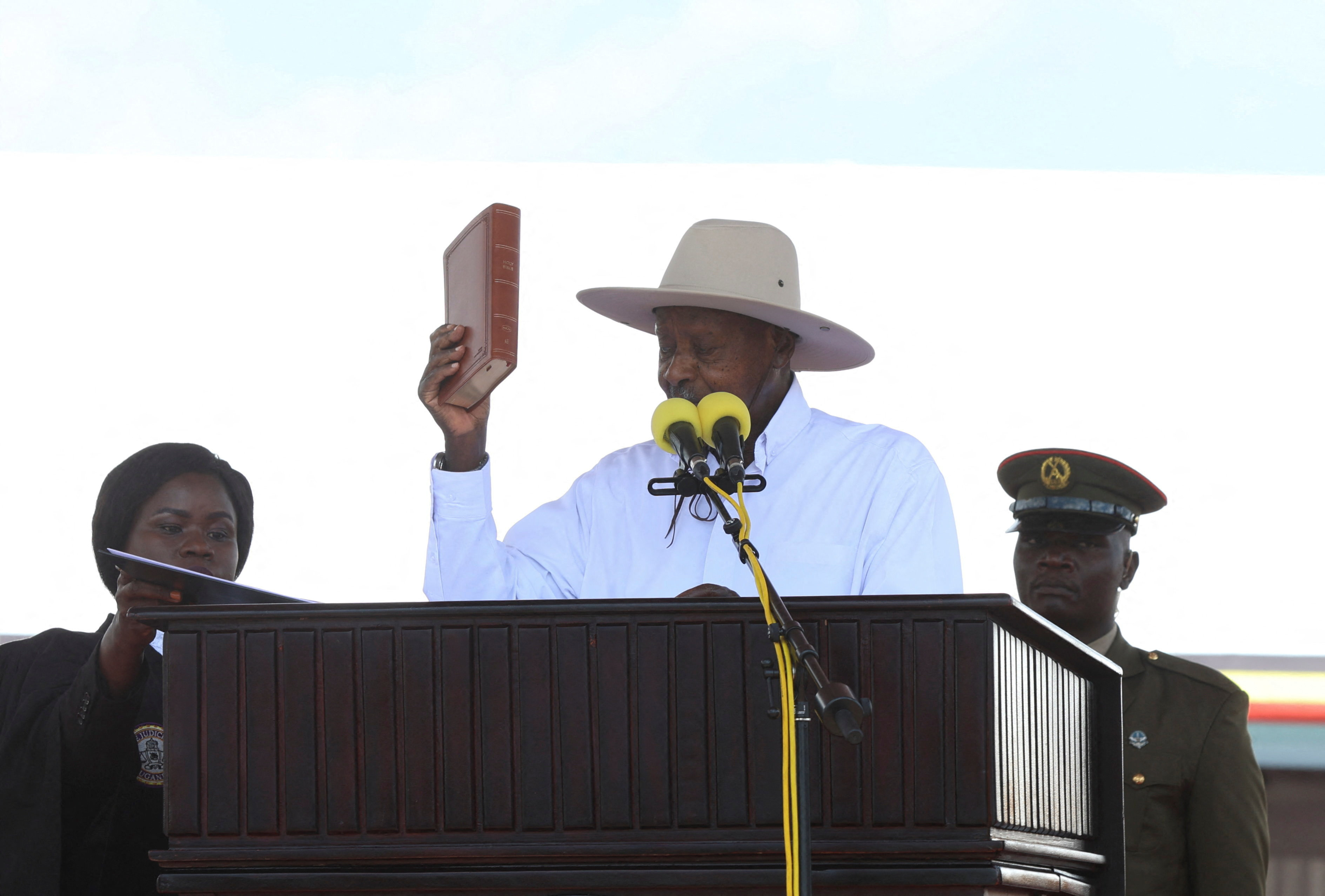 Uganda's President and the leader of ruling National Resistance Movement (NRM) party, Yoweri Museveni, holds up the Bible as he is sworn-in after being declared the winner of the country’s presidential election, extending his decades-long rule at the Kololo grounds in Kampala, Uganda May 12, 2026. REUTERS/Michael Muhati