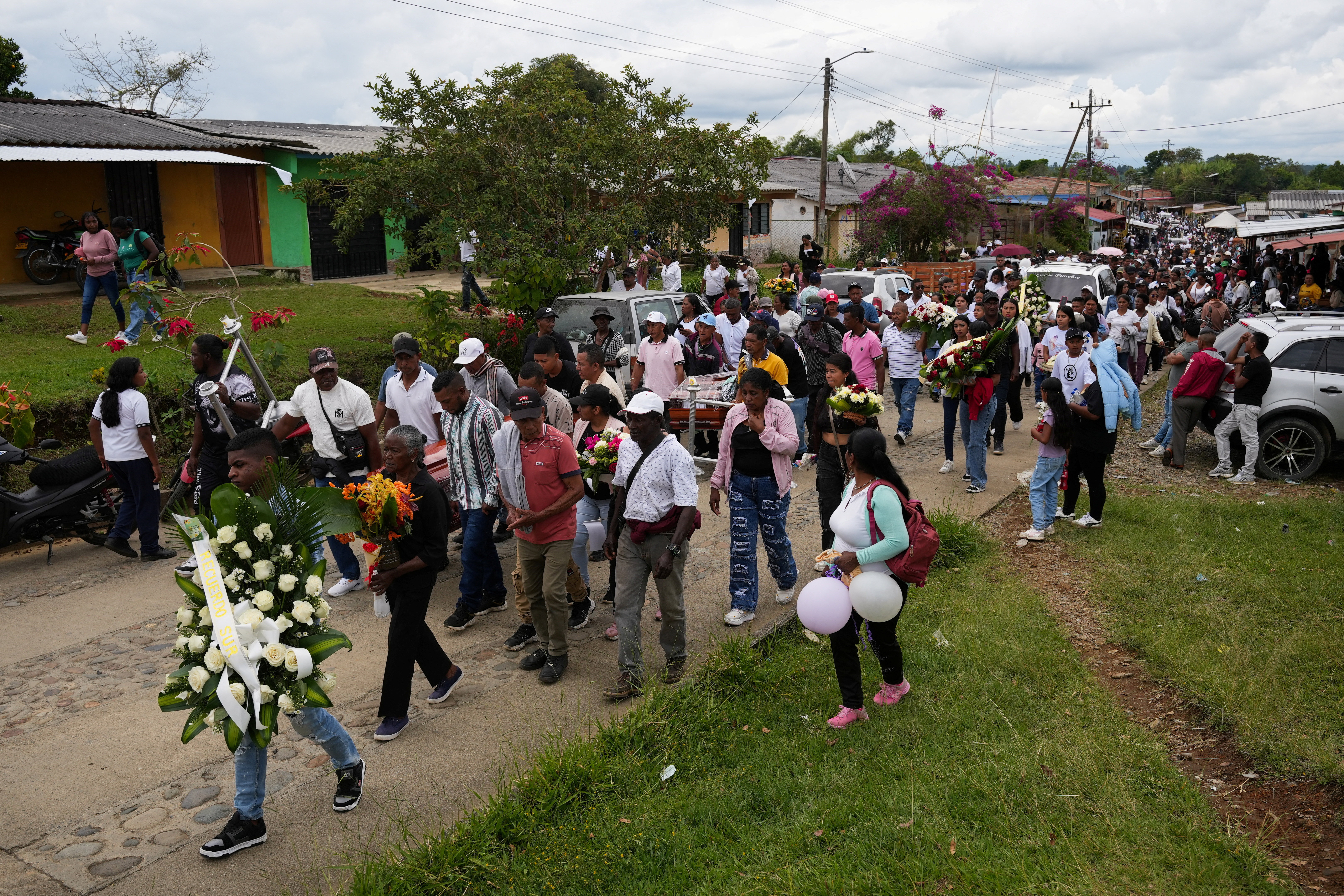 Family and community members walk in a procession with caskets during a funeral service for victims of a deadly attack that authorities blamed on a dissident faction of the former FARC guerrilla group, in Cajibio, Colombia April 28, 2026. REUTERS/Jair Coll