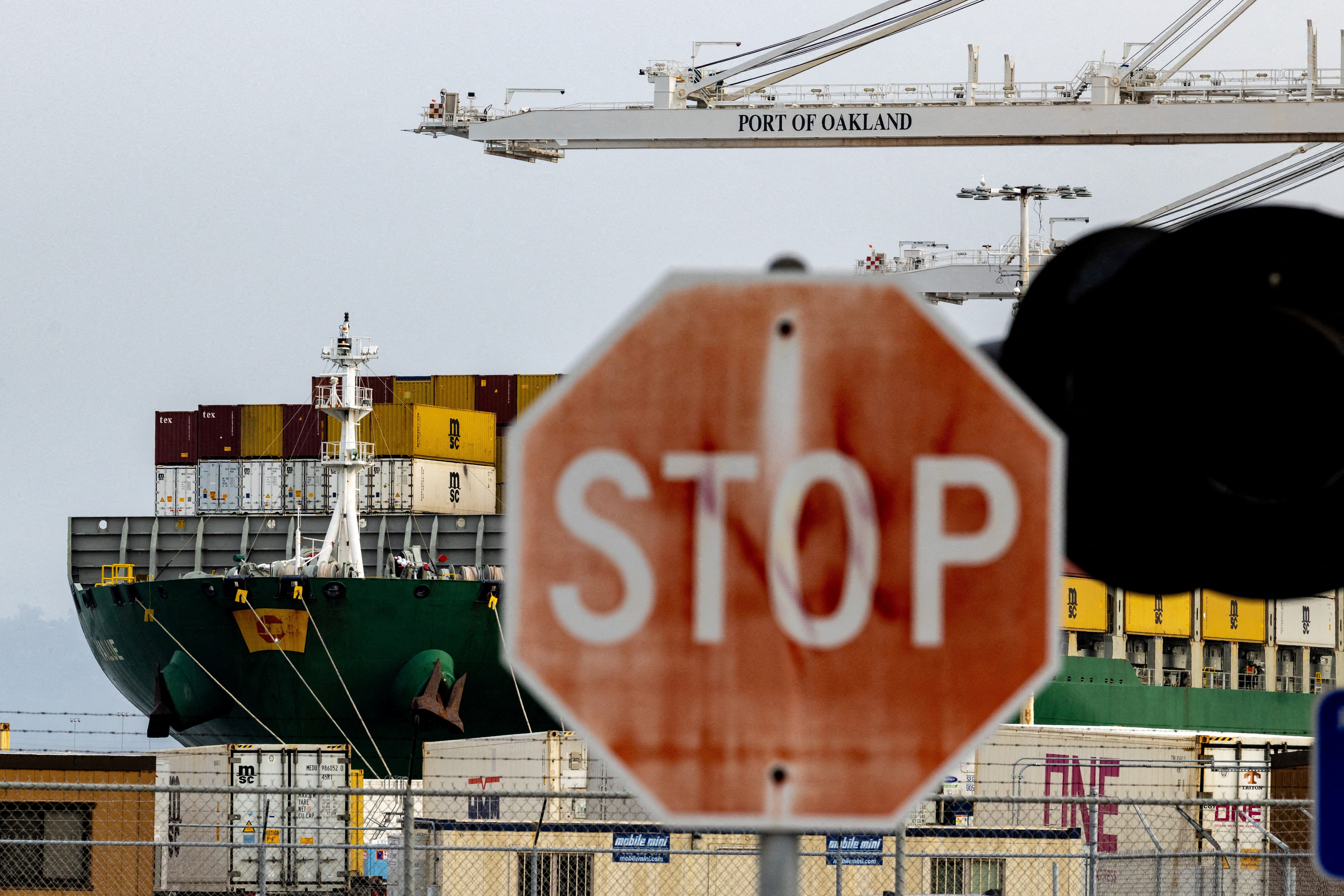 FILE PHOTO: A view of cargo ship with shipping containers at the port of Oakland following the Supreme Court's ruling that Trump had exceeded his authority when he imposed tariffs, in Oakland, California, U.S., February 23, 2026. REUTERS/Carlos Barria/File Photo