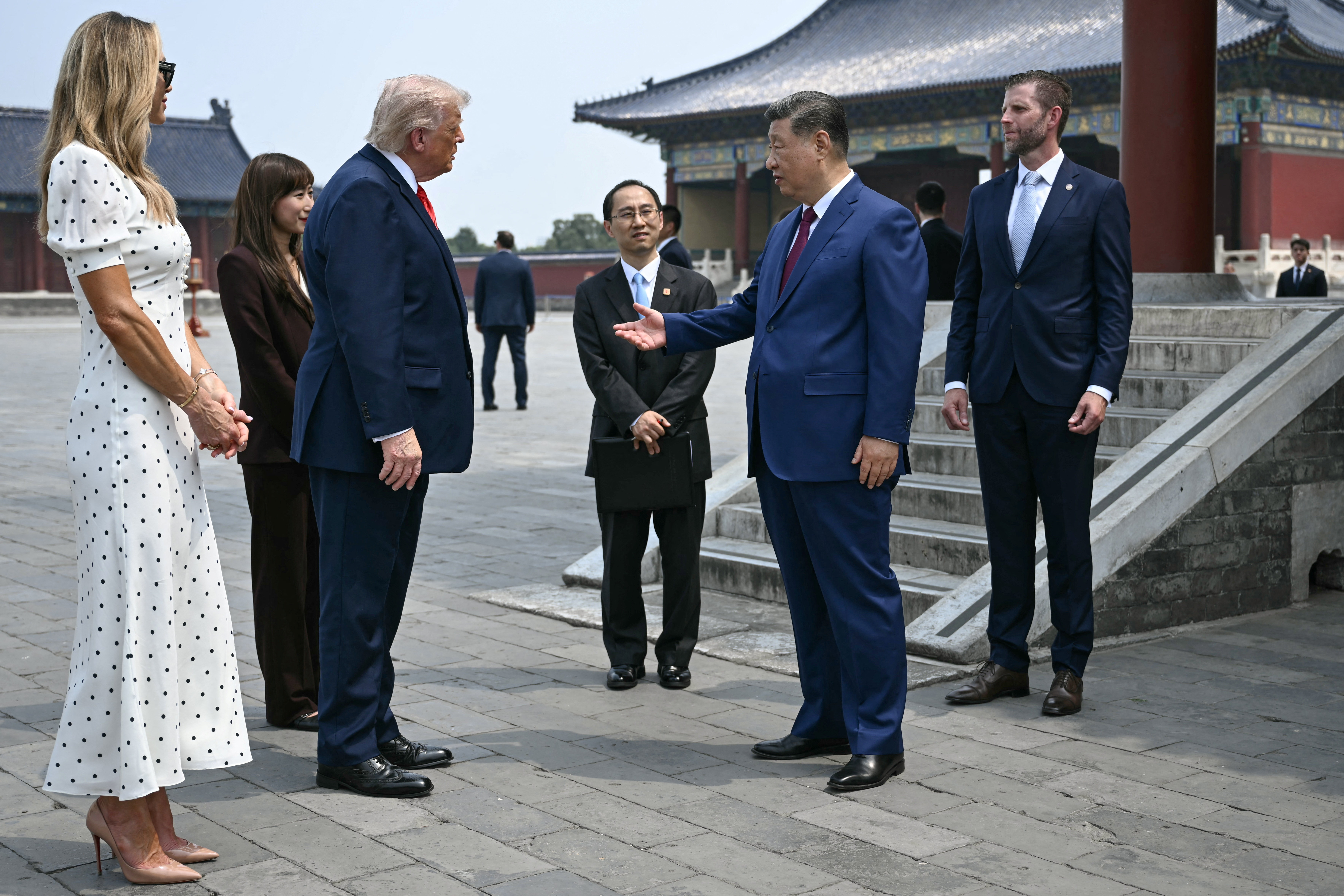 China's President Xi Jinping (2nd R) and US President Donald Trump (2nd L) talk as Eric Trump (R) and his spouse Lara Trump (L) look on during their visit to the Temple of Heaven in Beijing on May 14, 2026. BRENDAN SMIALOWSKI/Pool via REUTERS