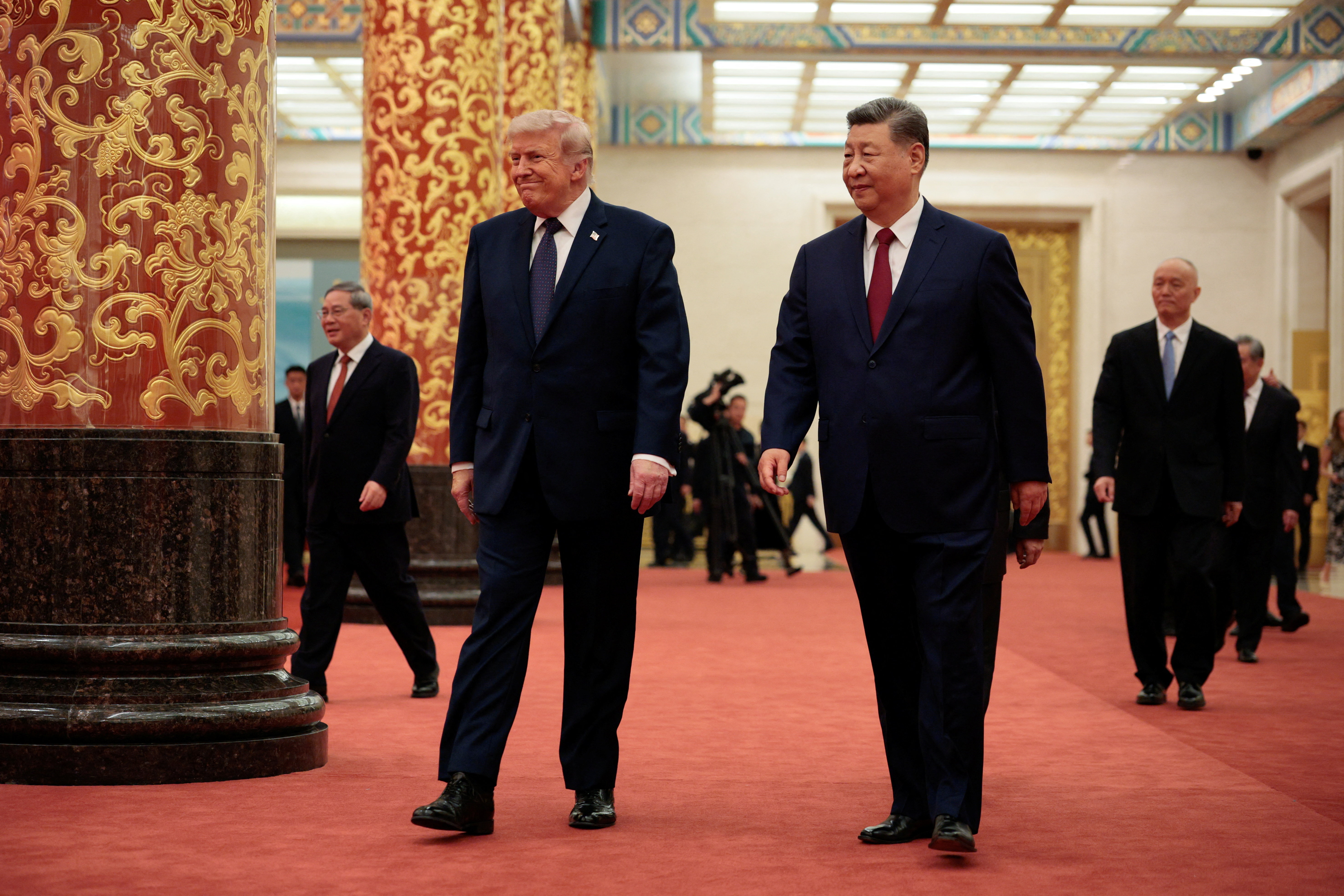 U.S. President Donald Trump and Chinese President Xi Jinping arrive to attend a state banquet at the Great Hall of the People in Beijing, China, May 14, 2026. REUTERS/Evan Vucci