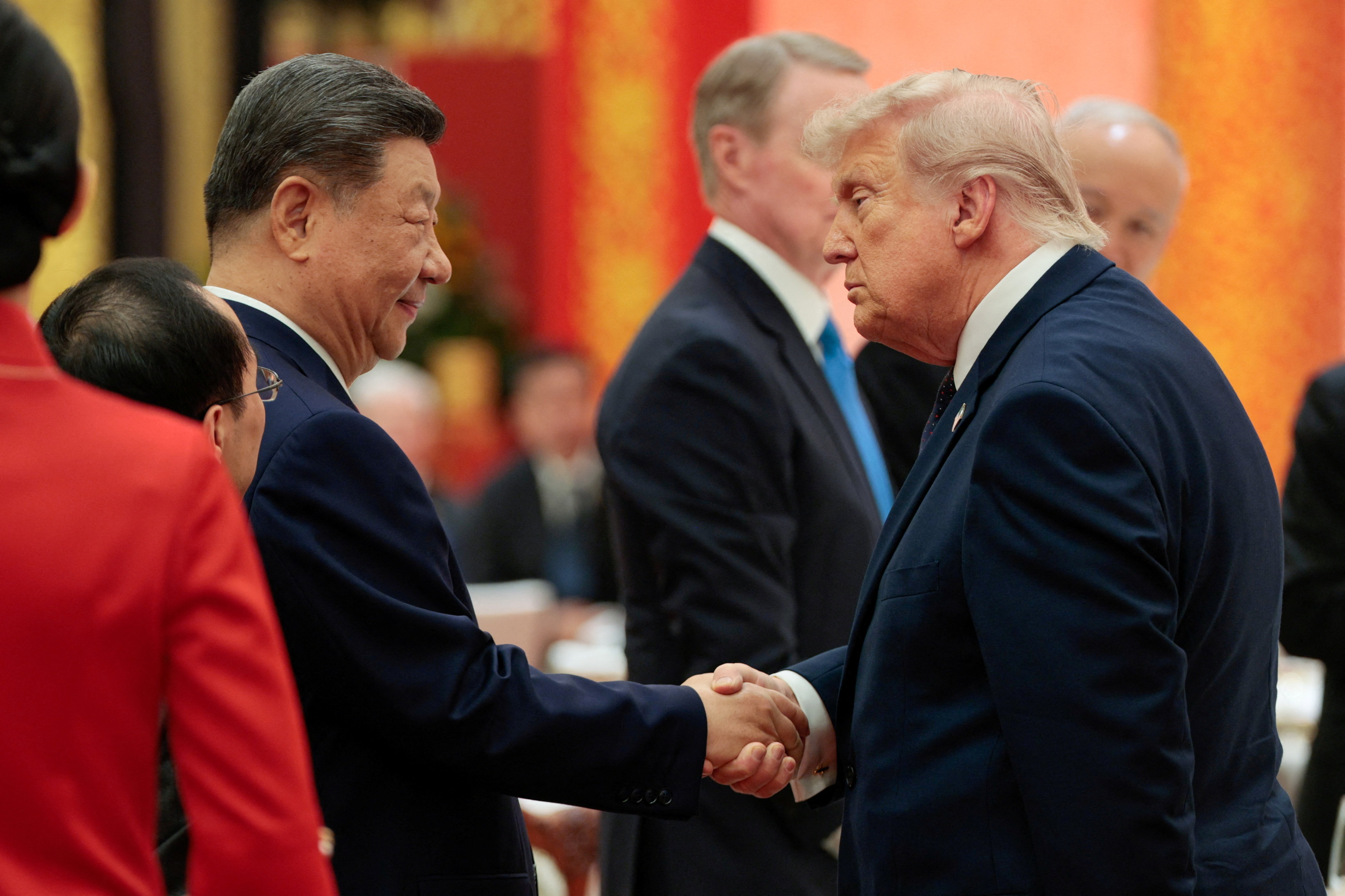 Chinese President Xi Jinping and U.S. President Donald Trump shake hands at a state banquet at the Great Hall of the People in Beijing, China, May 14, 2026. REUTERS/Evan Vucci