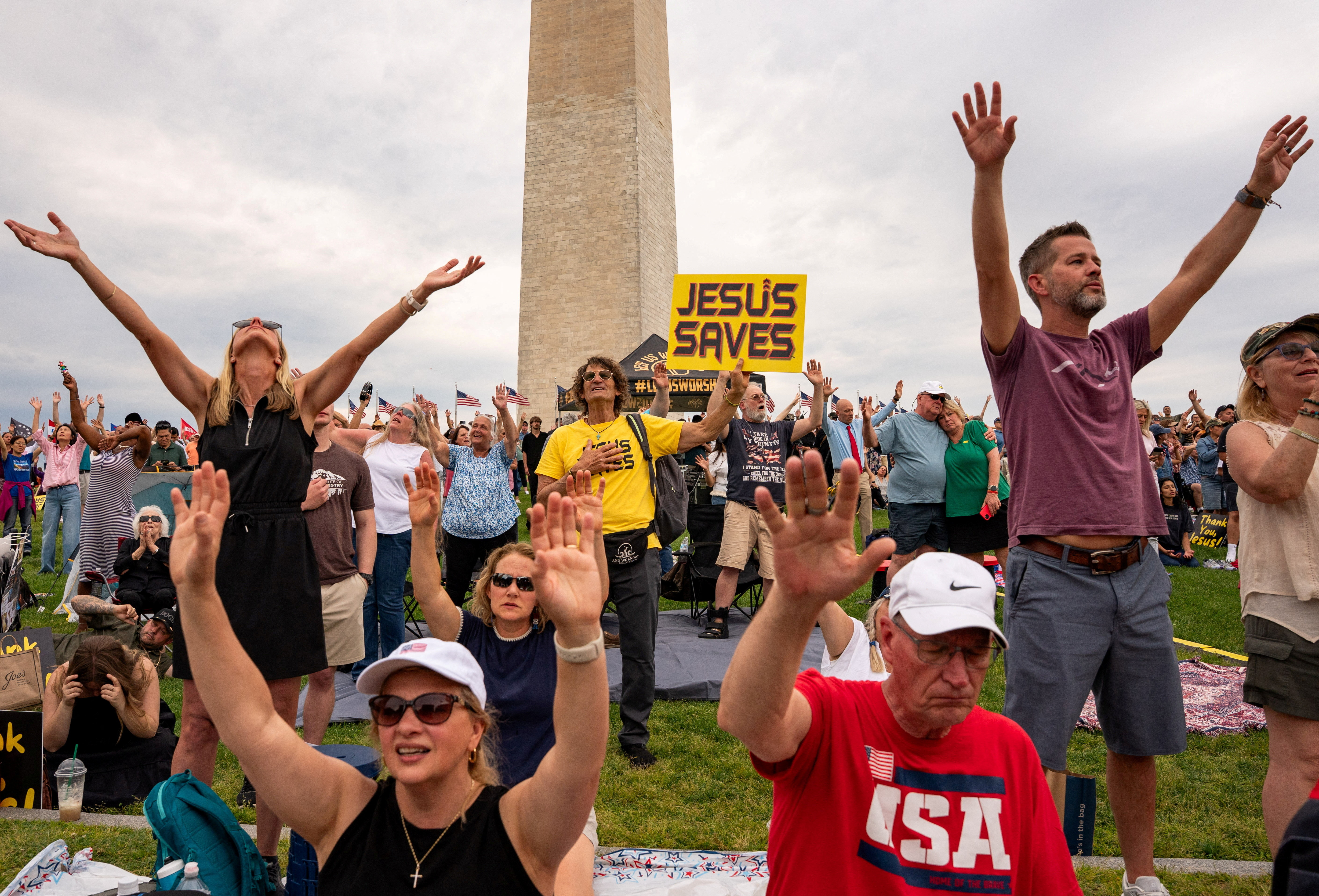 People worship near the Washington Monument during a worship service, ‘Let Us Worship’, ahead of the "Rededicate 250: National Jubilee of Prayer, Praise and Thanksgiving" event aimed to celebrate America's 250th birthday, in Washington, D.C. , U.S. May 16, 2026. REUTERS/Seth Herald TPX IMAGES OF THE DAY
