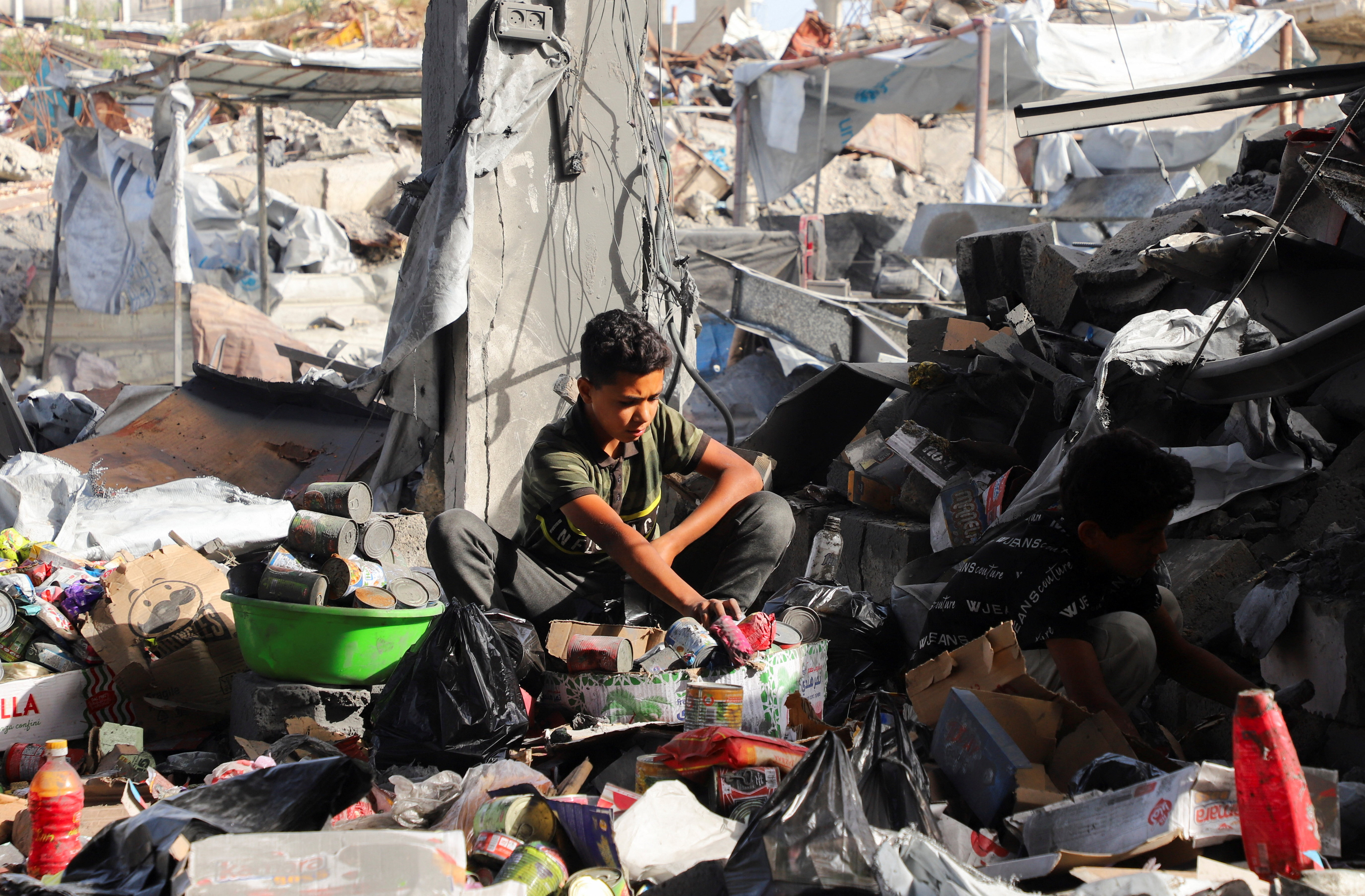 Palestinians inspect the site of an Israeli strike on a house that was pre-warned by the Israeli military to evacuate before the strike was carried out late on Monday, in Jabalia refugee camp in the northern Gaza Strip May 19, 2026. REUTERS/Ebrahim Hajjaj