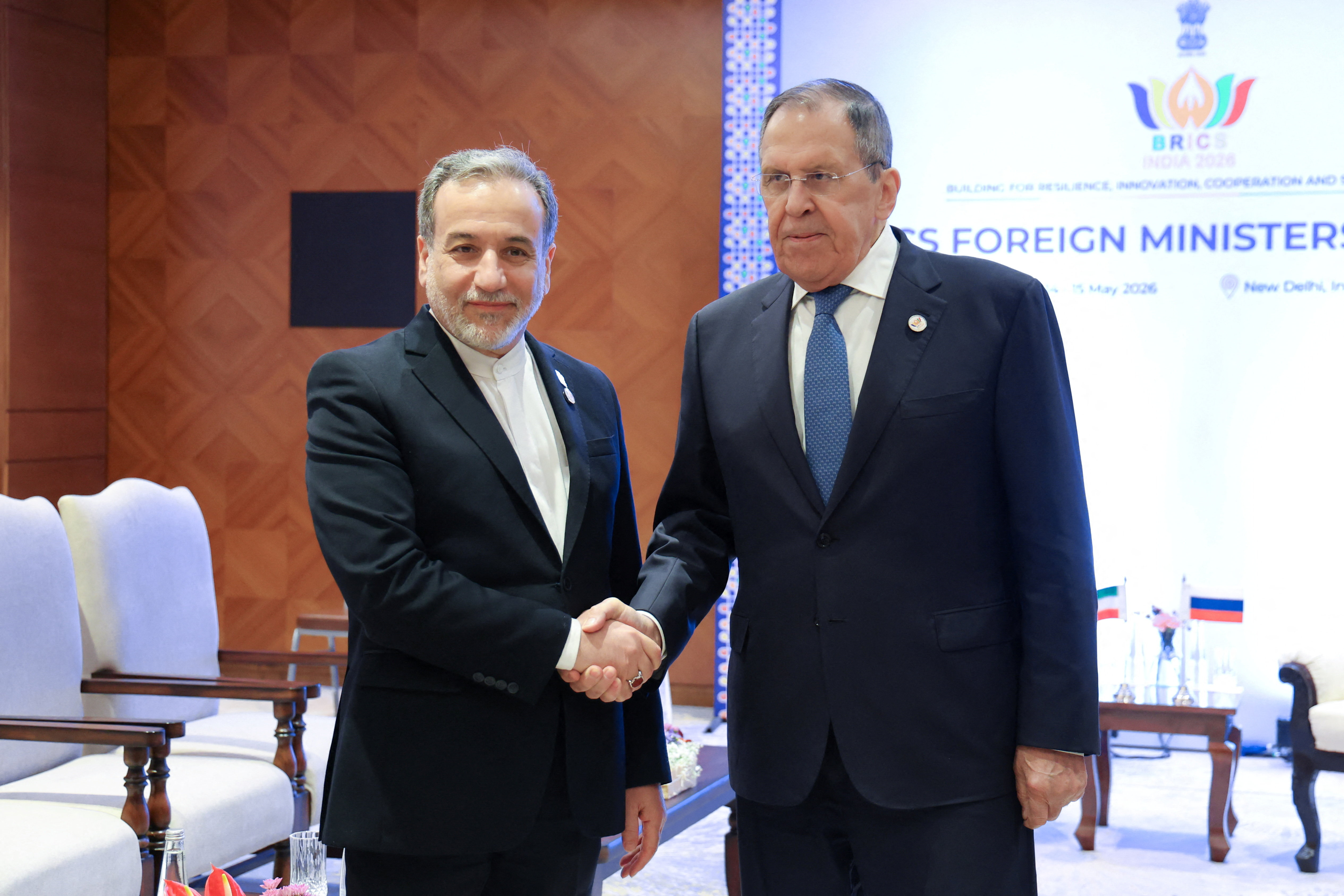 Russia's Foreign Minister Sergei Lavrov shakes hands with Iran's Foreign Minister Abbas Araqchi during a meeting on the sidelines of the BRICS foreign ministers' summit in New Delhi, India, May 14, 2026. Russian Foreign Ministry/Handout via REUTERS ATTENTION EDITORS - THIS IMAGE WAS PROVIDED BY A THIRD PARTY. NO RESALES. NO ARCHIVES. MANDATORY CREDIT.