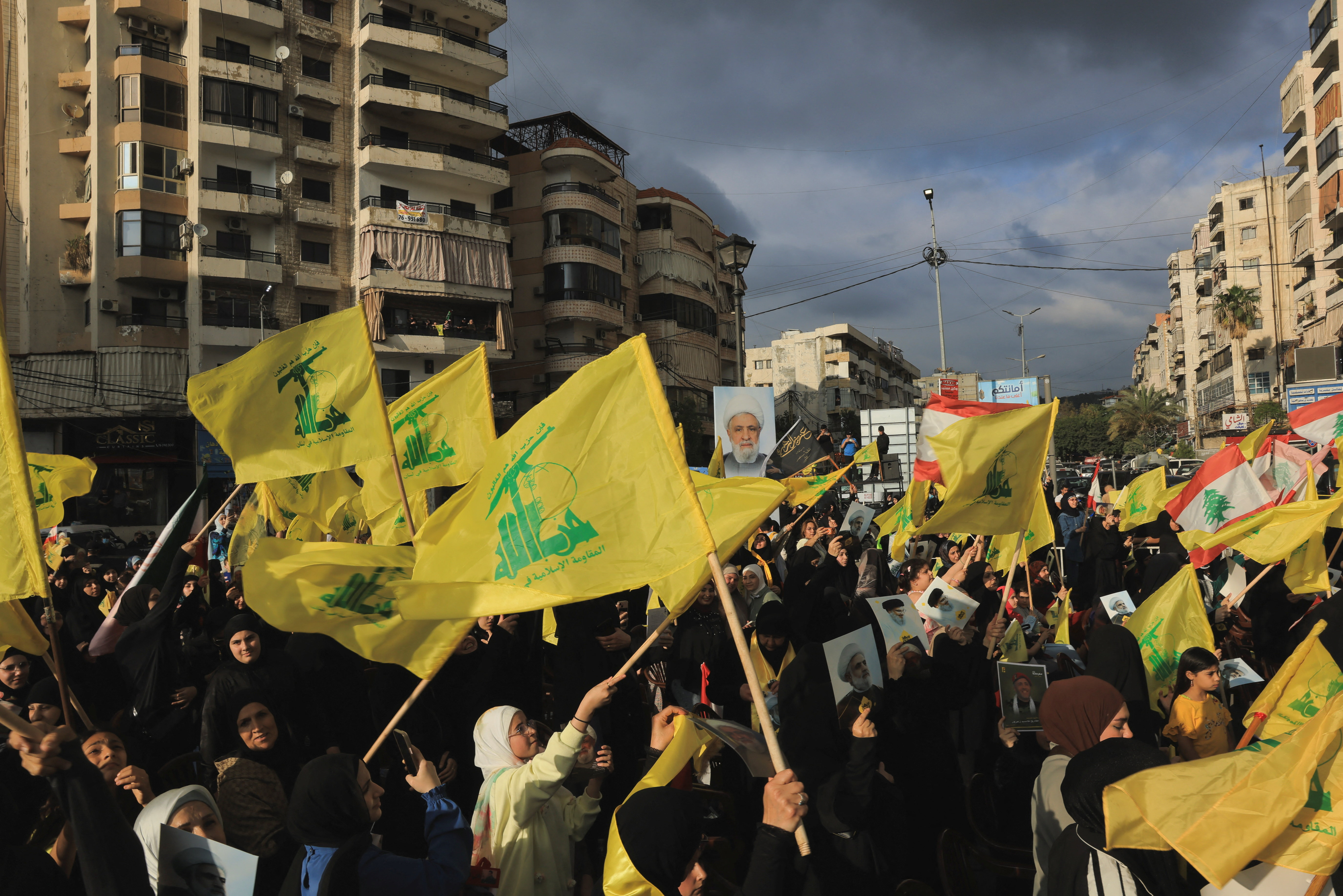 People hold Hezbollah flags while commemorating Israel’s withdrawal from southern Lebanon in 2000, in the southern suburbs of Beirut, Lebanon, May 25, 2026. REUTERS/Raghed Waked