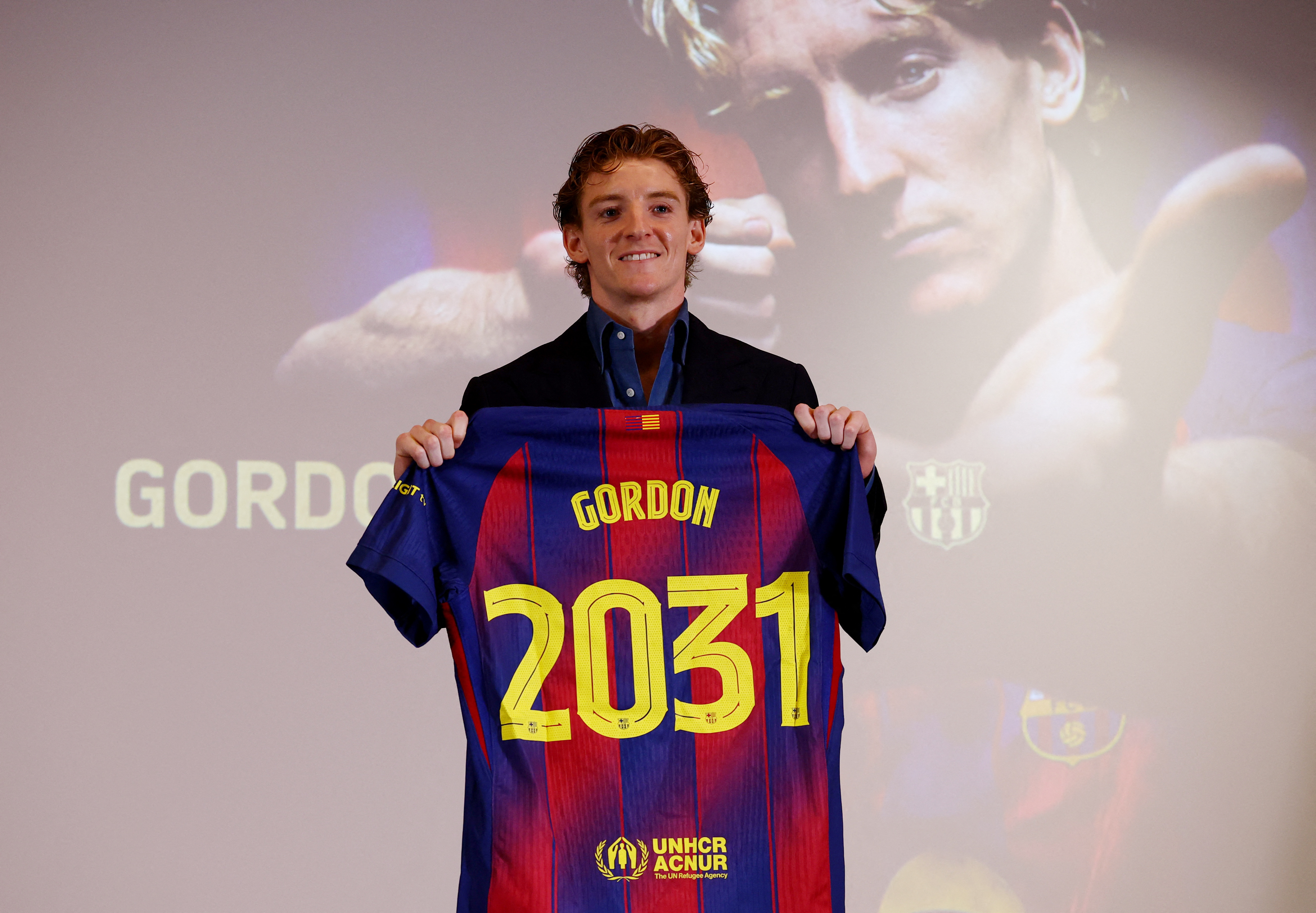 Soccer Football - Anthony Gordon signs for FC Barcelona - Spotify Camp Nou, Barcelona, Spain - May 29, 2026 Anthony Gordon poses as he holds a shirt after signing for FC Barcelona REUTERS/Albert Gea