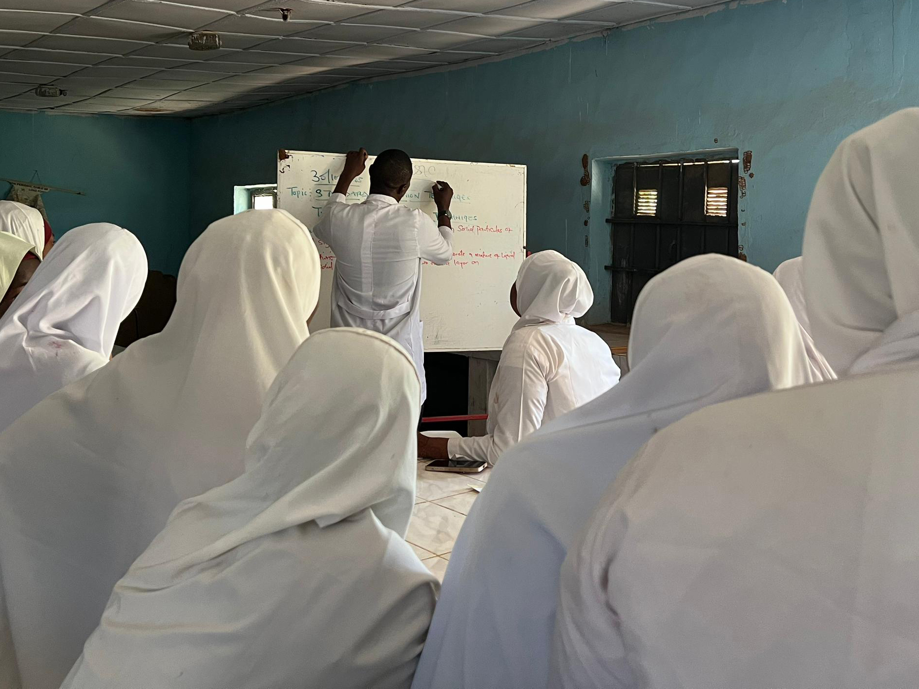Women in northern Nigeria are returning to school years after dropping out, but many must balance childcare, household duties and costs. [Abdulaziz Bagwai /Al Jazeera]