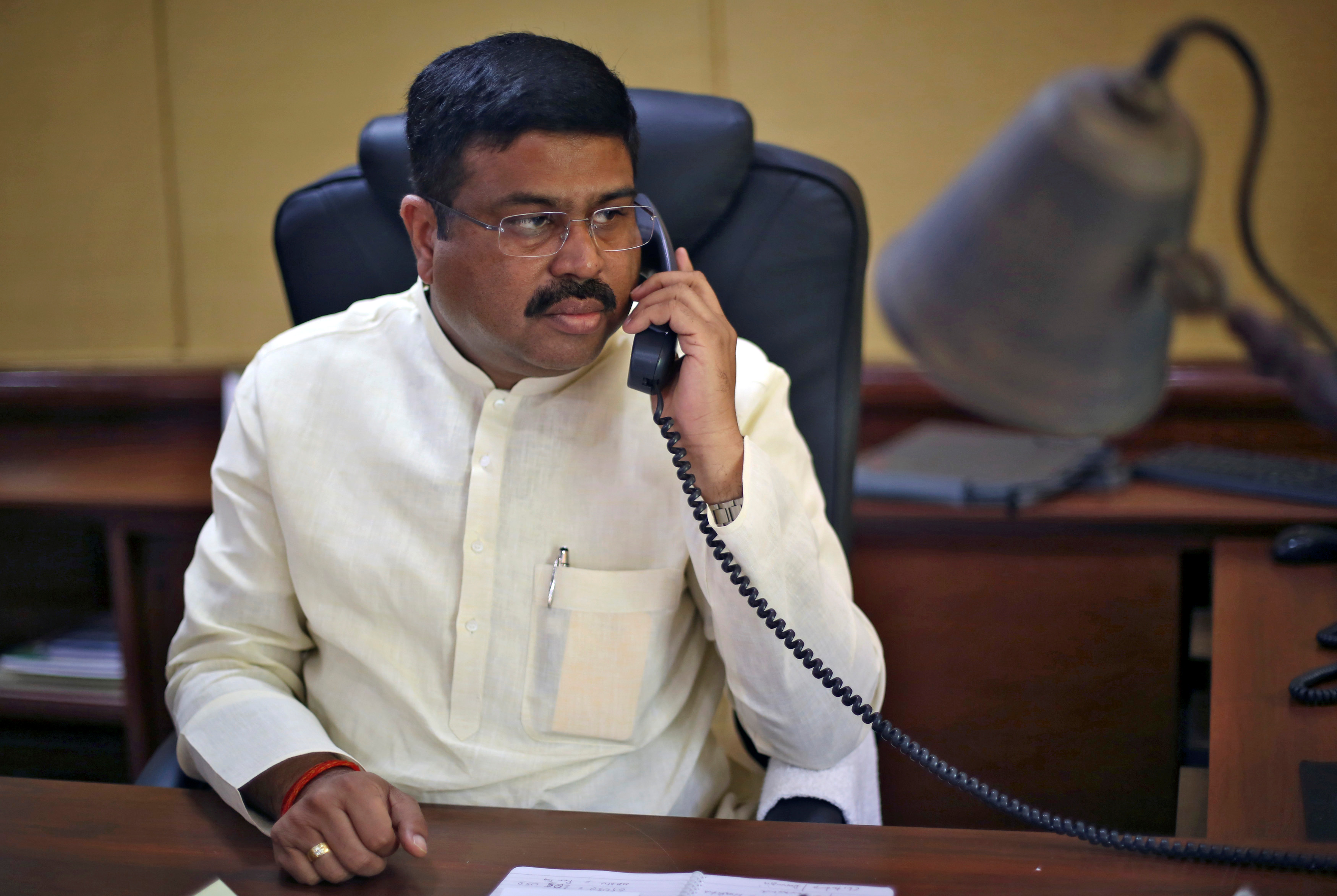 Education Minister Dharmendra Pradhan speaks on the phone during an interview with Reuters in New Delhi, India, May 5, 2016