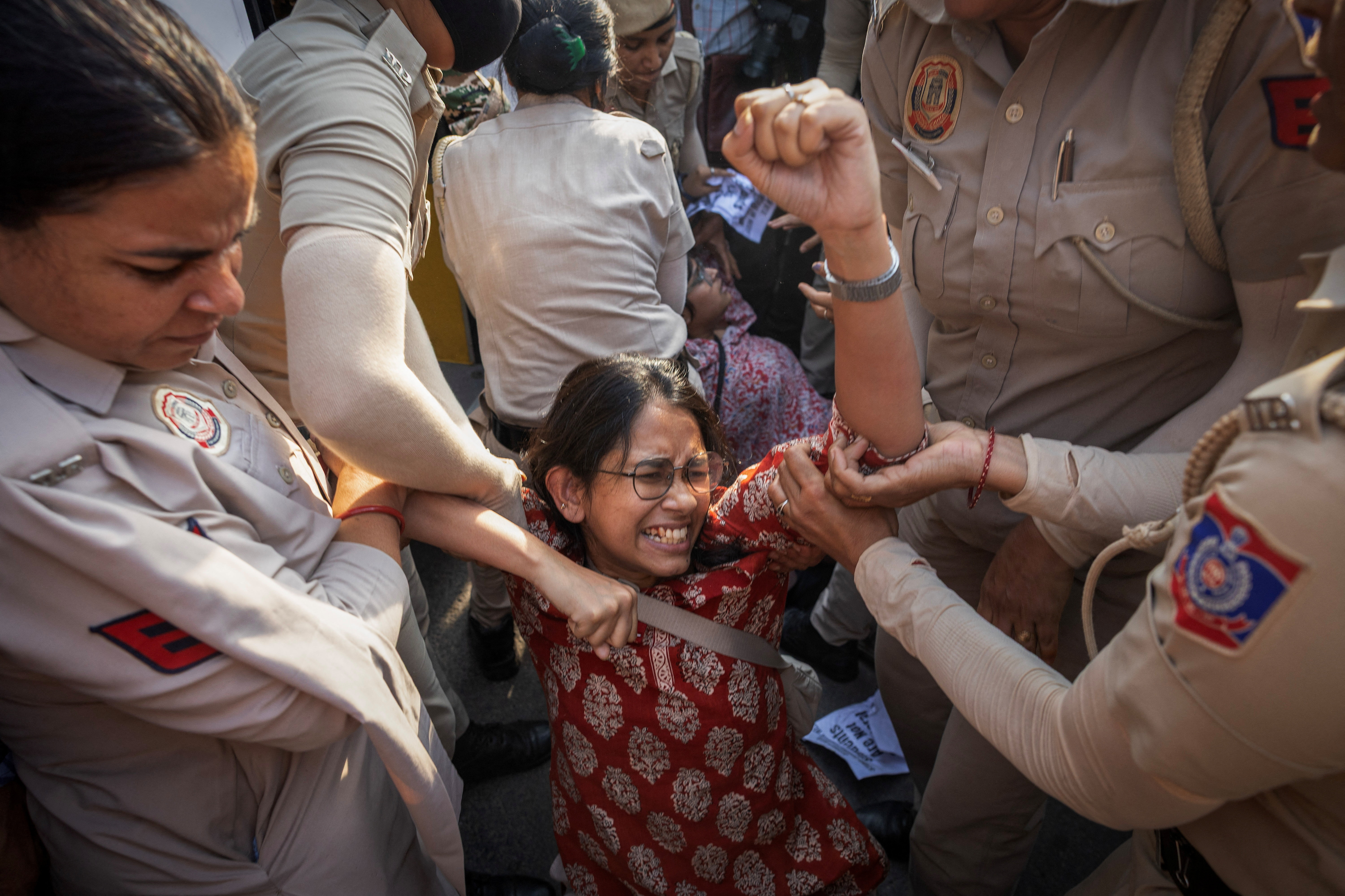 Police detain a member of the Students’ Federation of India during a protest in New Delhi against the cancellation of the National Eligibility-cum-Entrance Test, a college entrance test, after authorities discovered its questions had been leaked