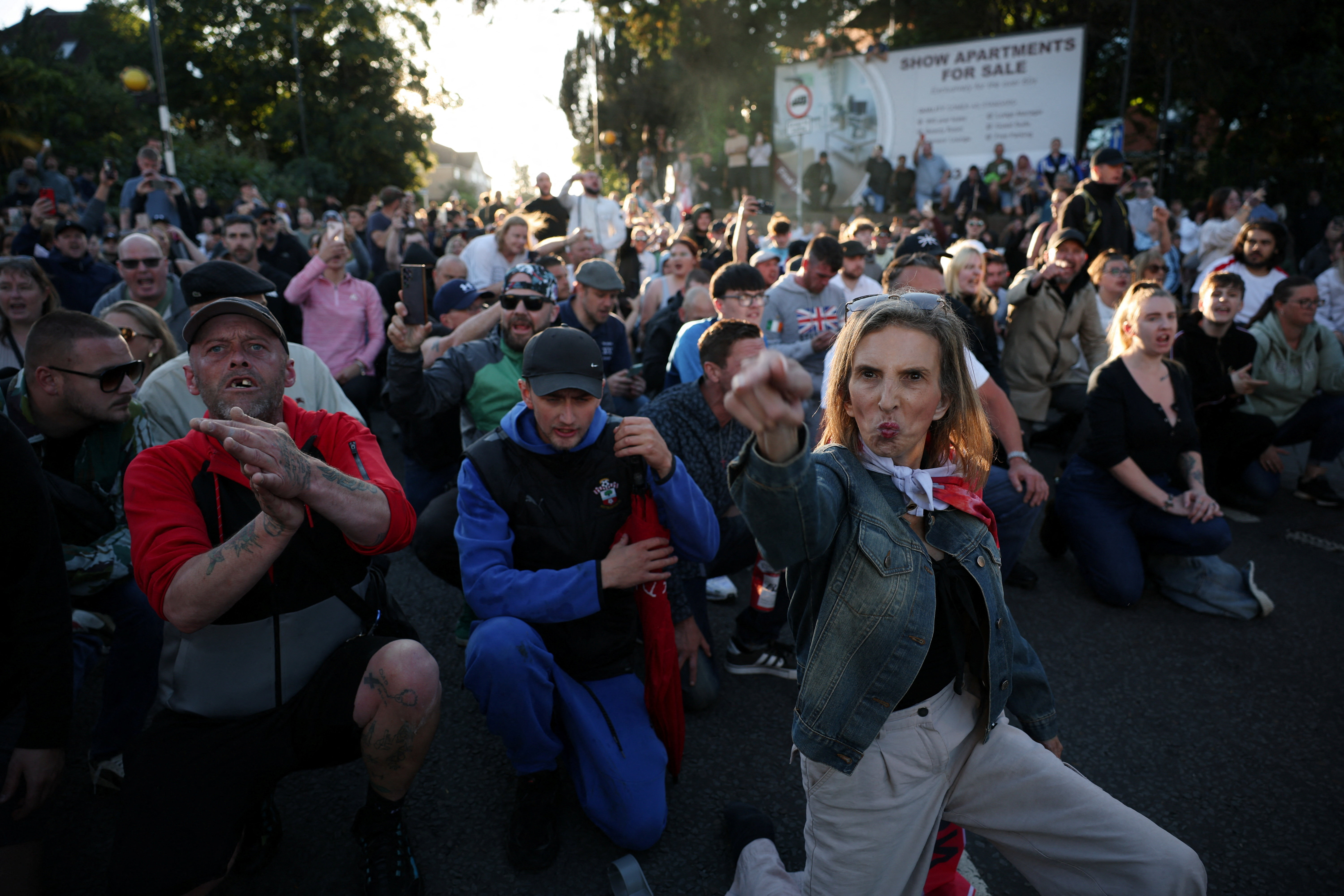 A protester gestures while others kneel, facing a police cordon near the place where student Henry Nowak was killed, during a demonstration following the conviction of Vikrum Digwa for the murder of Nowak in Southampton, Britain, June 2, 2026. REUTERS/Isabel Infantes