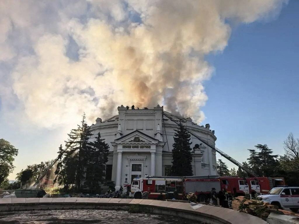Firefighters extinguish a fire in a building.