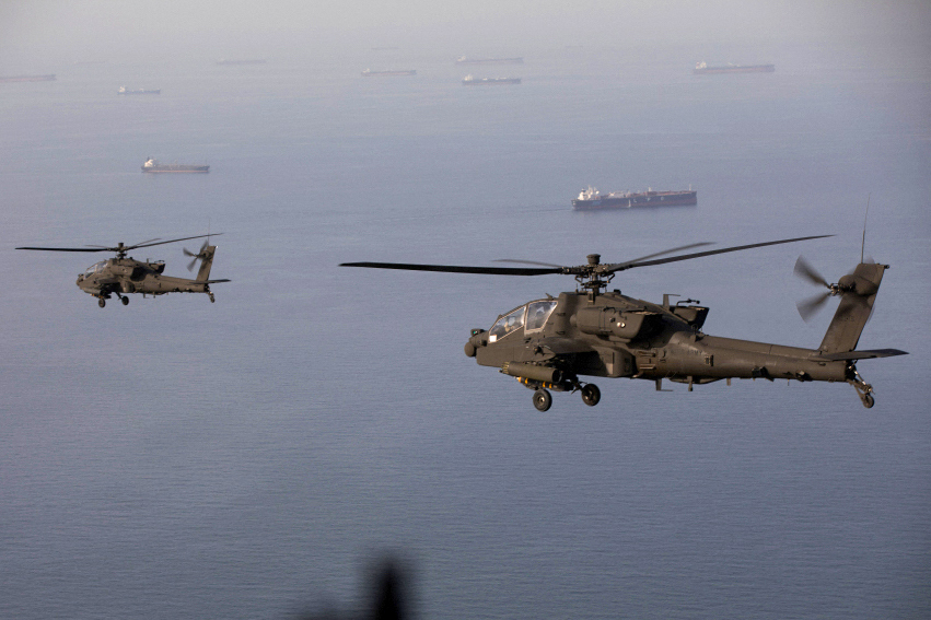 This handout photo released by US Central Command via their X account (@CENTCOM) on April 18, 2026 shows AH-64 Apaches flying above the Strait of Hormuz during a patrol on April 17, 2026. Iran's military declared the Strait of Hormuz closed again on April 18, prompting ships to abandon attempts to transit and President Donald Trump to warn Tehran against trying to "blackmail" the United States. On April 17, Tehran had declared the strait, which usually carries a fifth of the world's oil and liquefied natural gas, open after a ceasefire was agreed in Israel's war with Iran's ally Hezbollah in Lebanon. (Photo by US Central Command (CENTCOM) / AFP) / RESTRICTED TO EDITORIAL USE - MANDATORY CREDIT "AFP PHOTO / US CENTRAL COMMAND " - HANDOUT - NO MARKETING NO ADVERTISING CAMPAIGNS - DISTRIBUTED AS A SERVICE TO CLIENTS