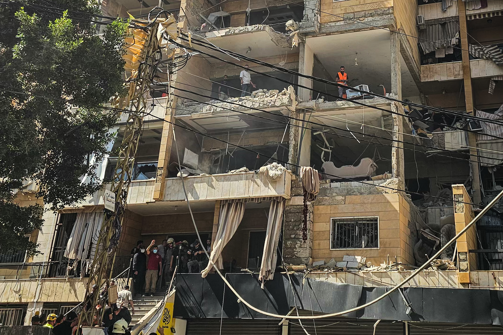 First responders inspect damage at the site of an Israeli airstrike on an apartment building in Beirut's southern suburbs on June 7, 2026. An Israeli attack on Beirut's southern suburbs hit two buildings in the area, Lebanese state media reported on June 7, after Israel said it struck the Hezbollah stronghold. (Photo by AFP) /