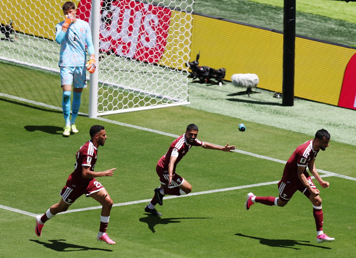 Boualem Khoukhi #16 of Qatar celebrates with teammates after scoring the team's first goal during the FIFA World Cup 2026 Group B match between Qatar and Switzerland