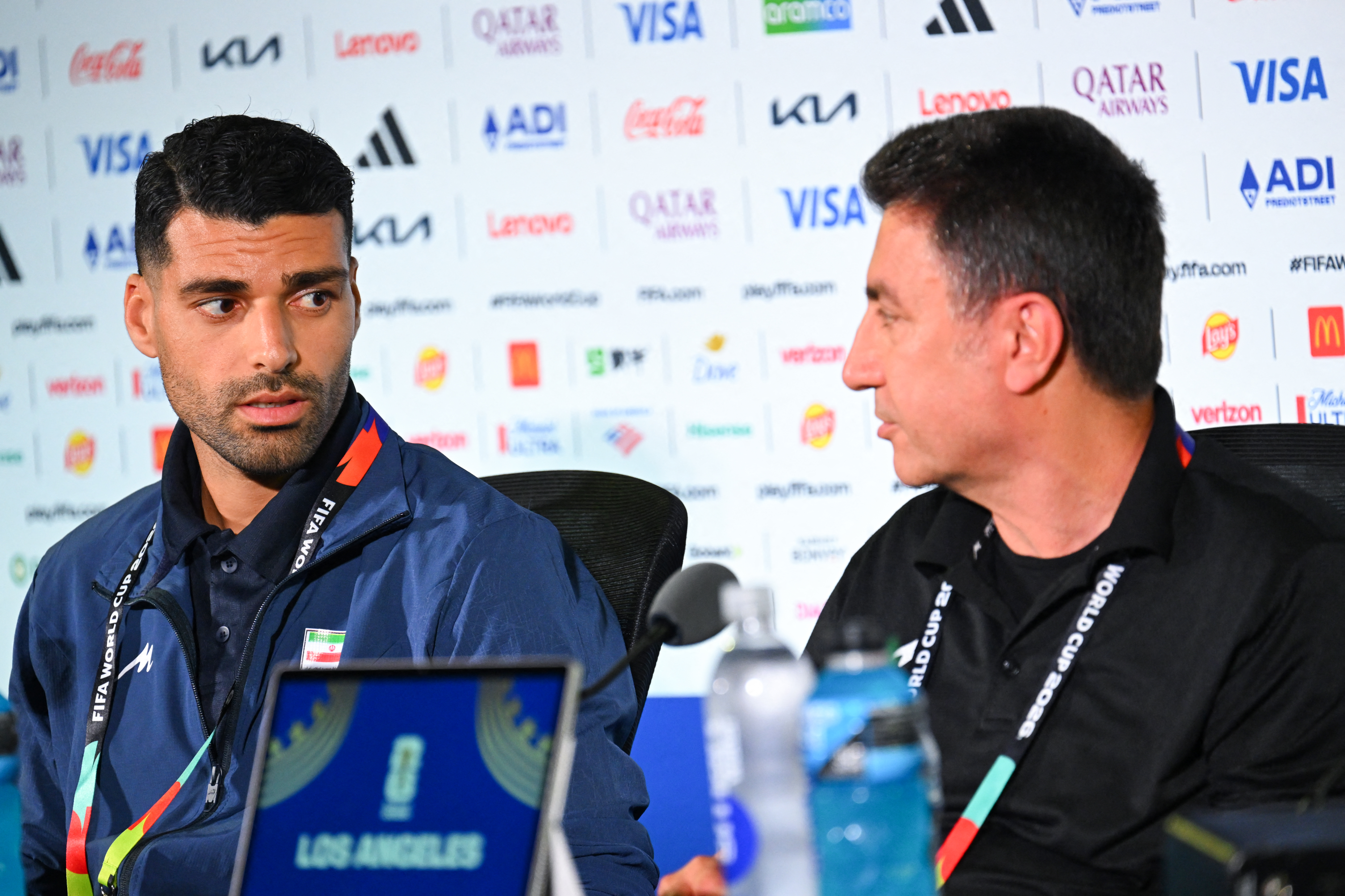 Iran's head coach Amir Ghalenoei (R) gives a press conference next to Irans forward #09 Mehdi Taremi at Los Angeles Stadium in Inglewood on June 14, 2026, on the eve of the 2026 World Cup football match between Iran and New Zealand. (Photo by Patrick T. FALLON / AFP)