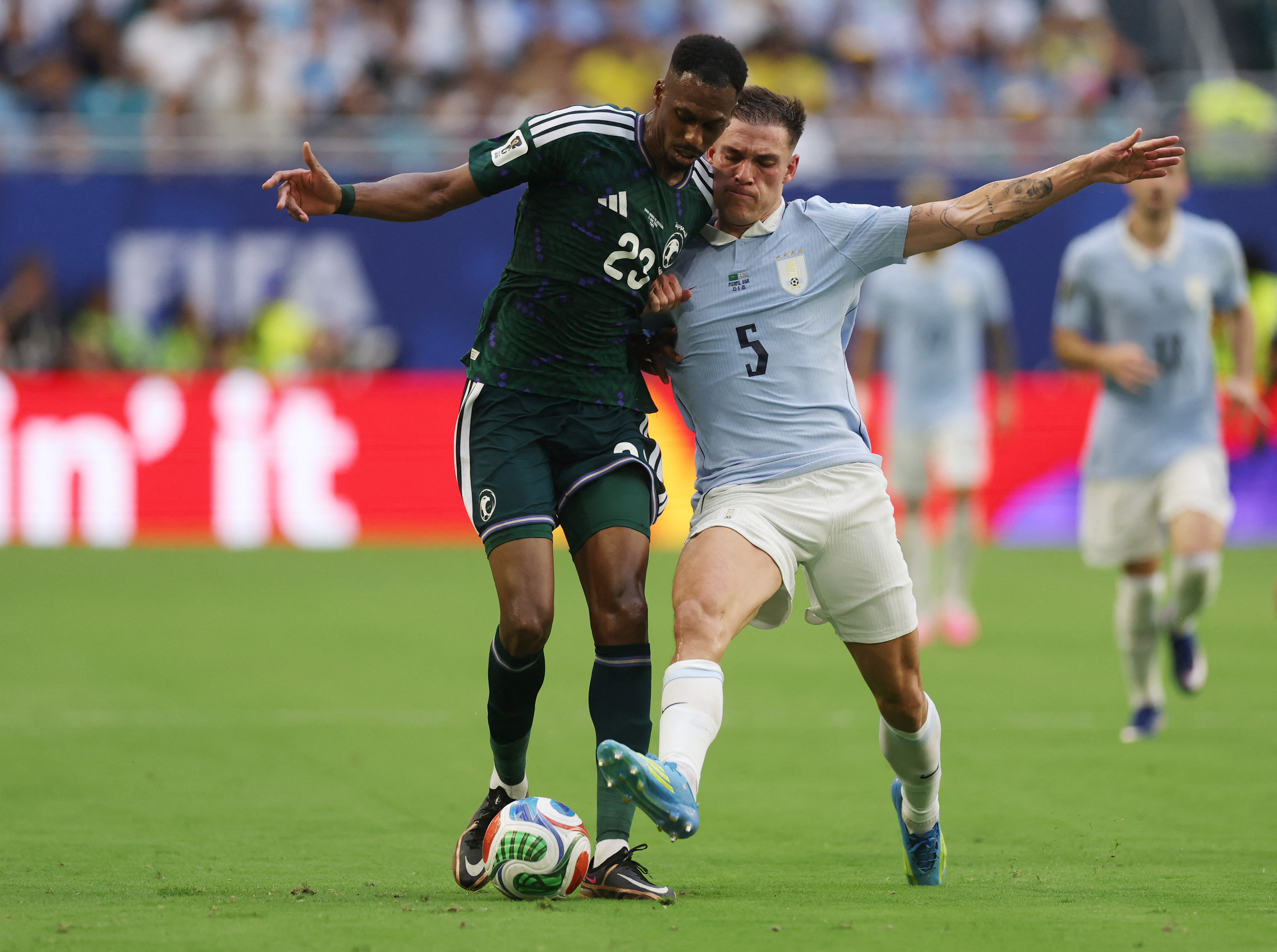 MIAMI, FLORIDA - JUNE 15: Mohamed Kanno #23 of Saudi Arabia and Manuel Ugarte #5 of Uruguay compete for the ball during the FIFA World Cup 2026 Group H match between Saudi Arabia and Uruguay at Miami Stadium on June 15, 2026 in Miami, Florida. Lars Baron/Getty Images/AFP (Photo by Lars Baron / GETTY IMAGES NORTH AMERICA / Getty Images via AFP)