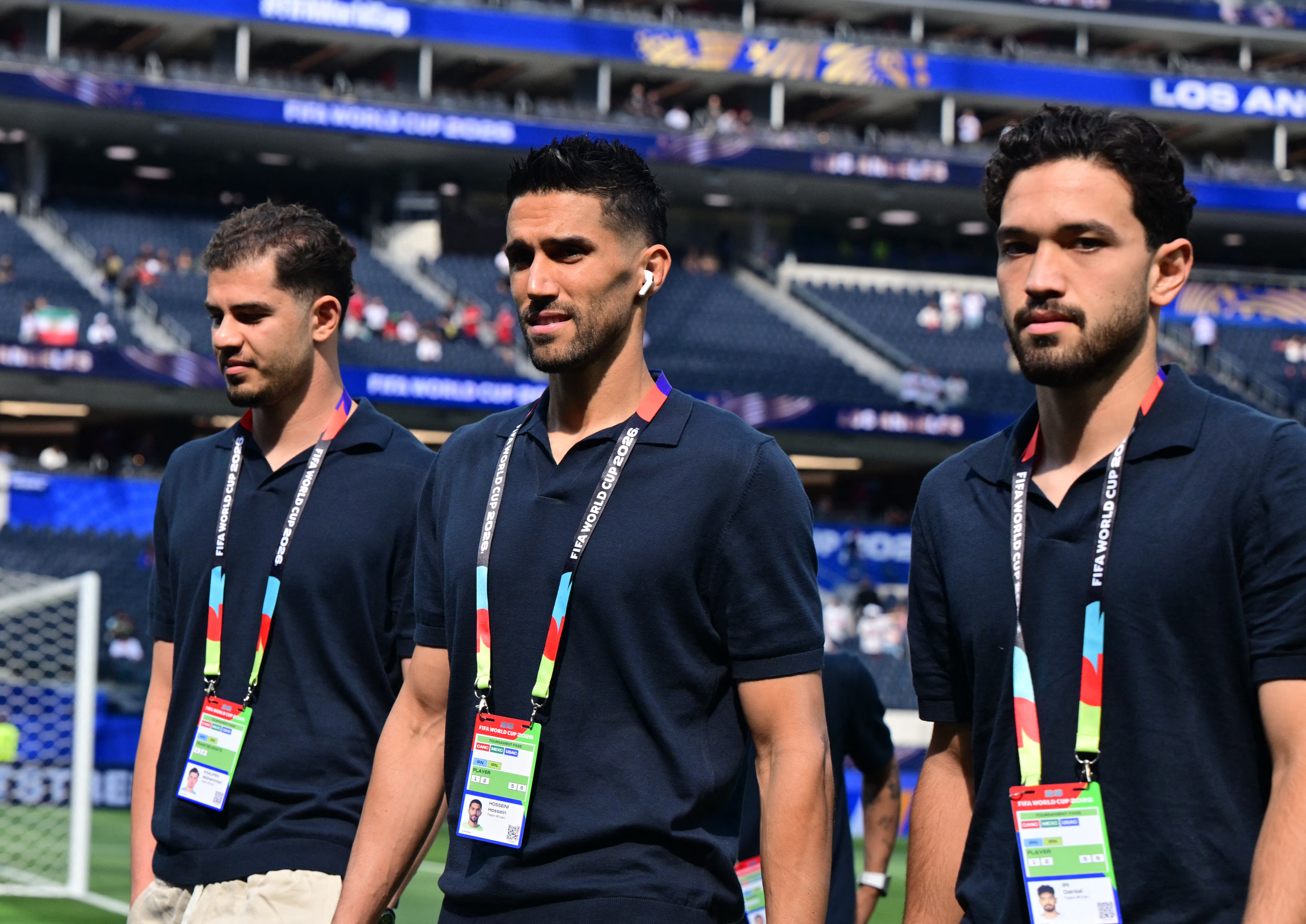 Iran's goalkeeper #22 Hossein Hosseini (C) and defender #25 Danial Iri (R) walk on the pitch ahead of the 2026 World Cup Group G football match between Iran and New Zealand at Los Angeles Stadium in Inglewood on June 15, 2026. (Photo by Frederic J. Brown / AFP)
