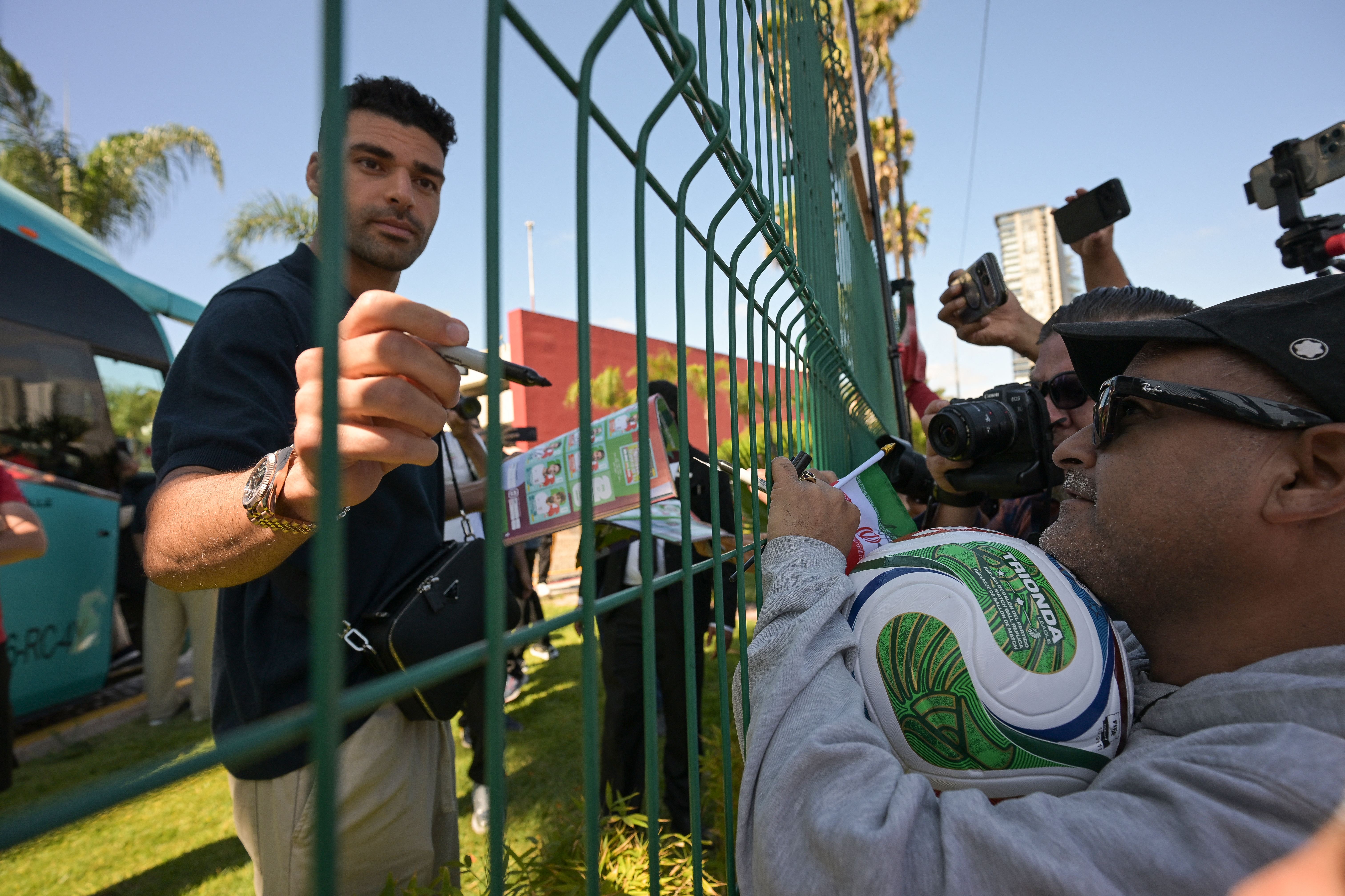 Iran’s star forward Mehdi Taremi signs autographs in Tijuana, Mexico, which was the home base for the team despite their three group matches all being played in the United States