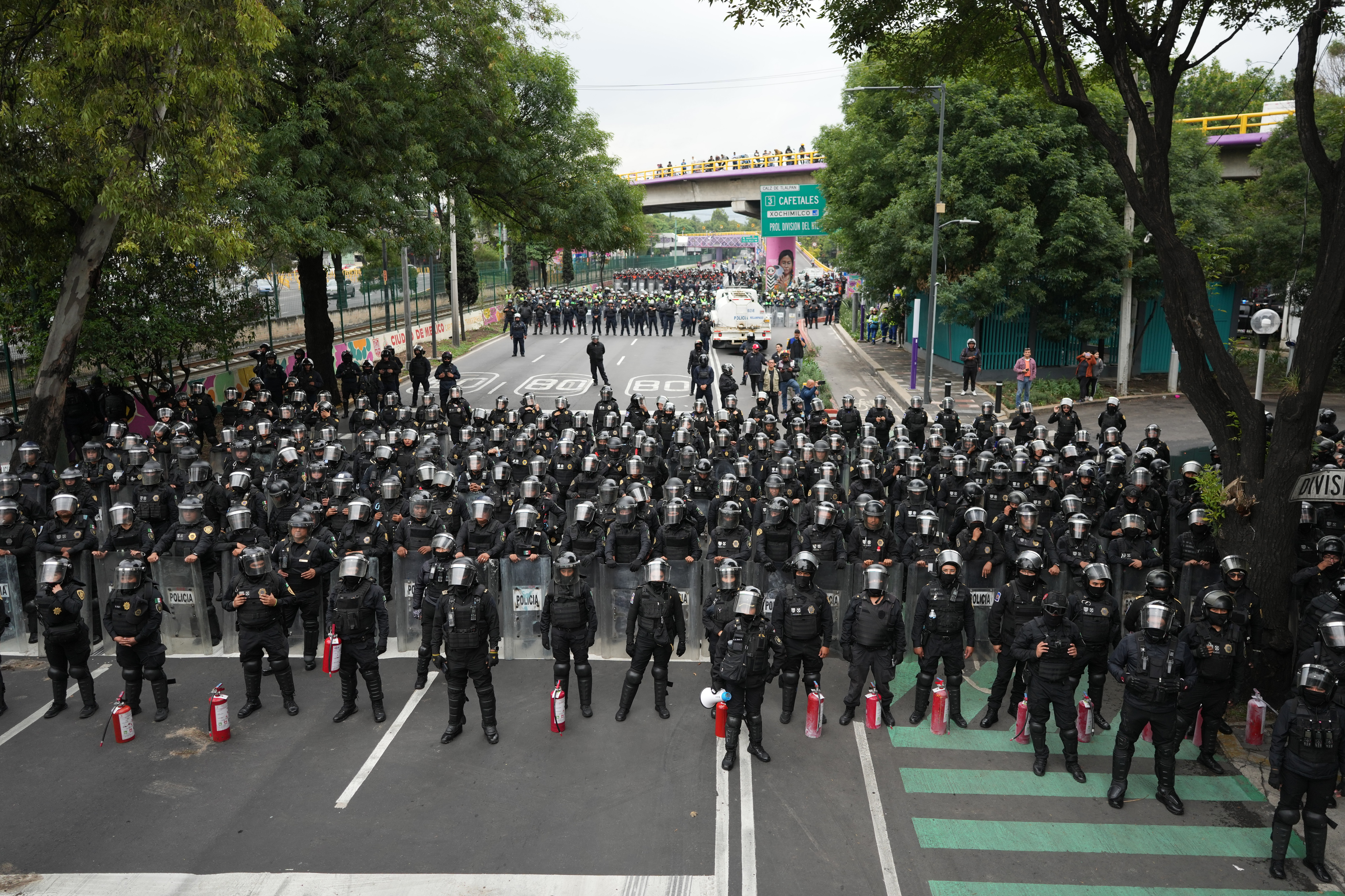 Police block an avenue to prevent protesting teachers from marching to the stadium that will host the opening match of the FIFA World Cup