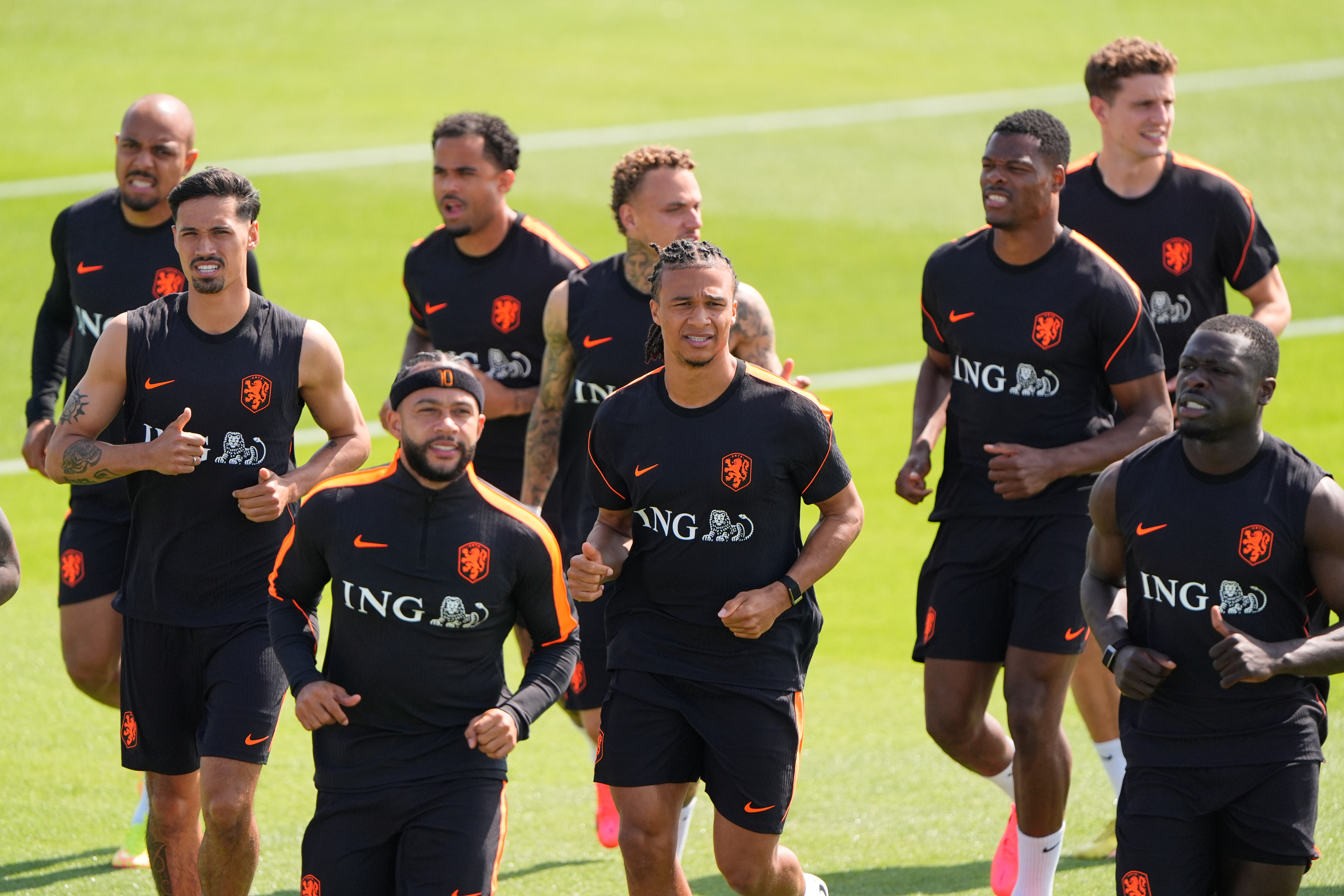 Netherlands team members practice on the pitch.
