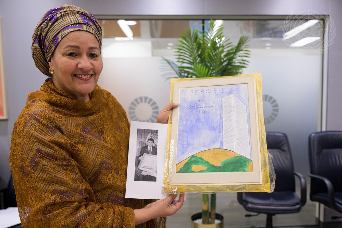 The author holding Muhammad Ali’s painting [Courtesy of the United Nations]