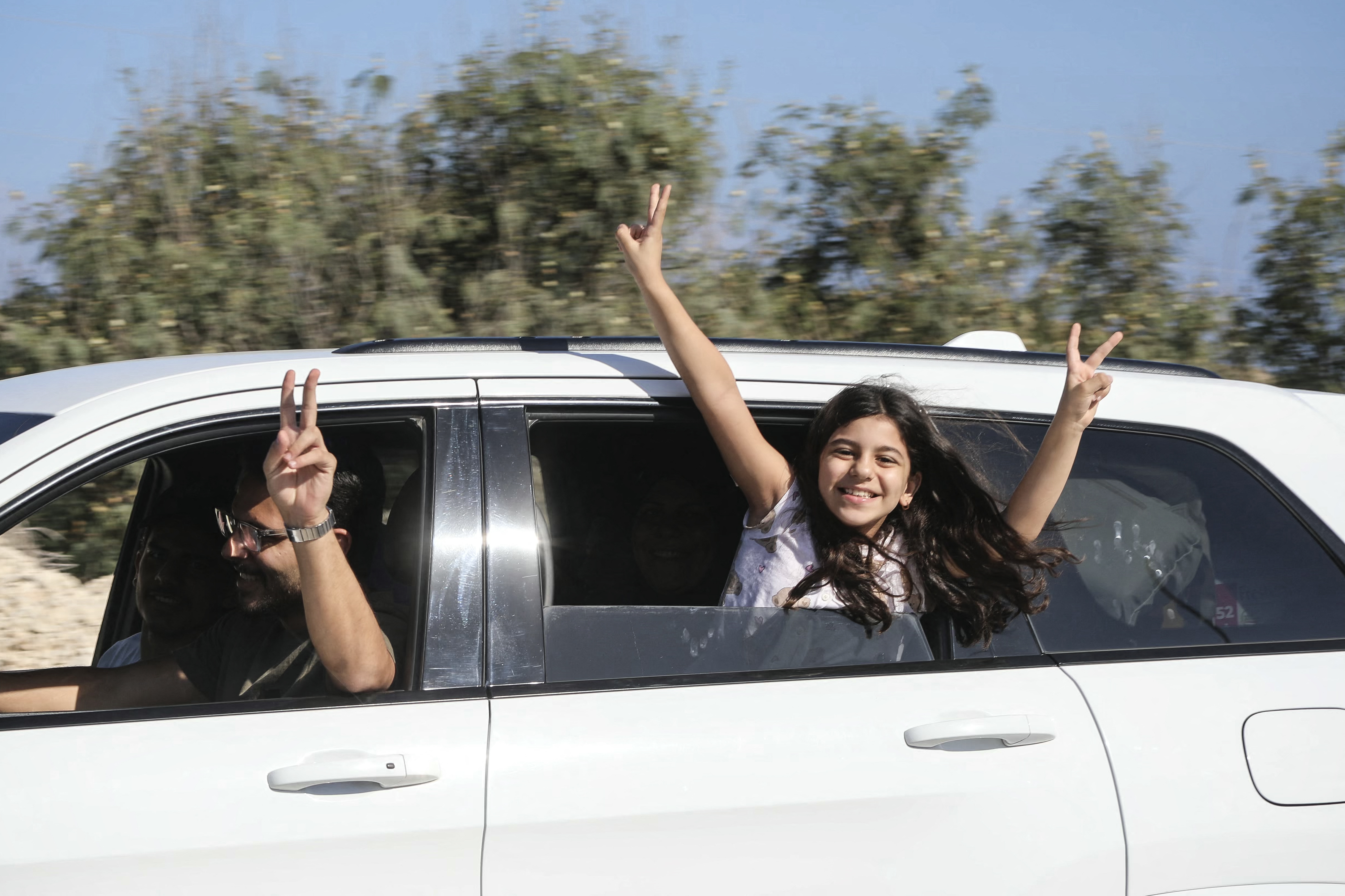 Displaced residents flash the V-sign as they cross the Bourj Rahal bridge on their way to their village in southern Lebanon on June 15, 2026.
