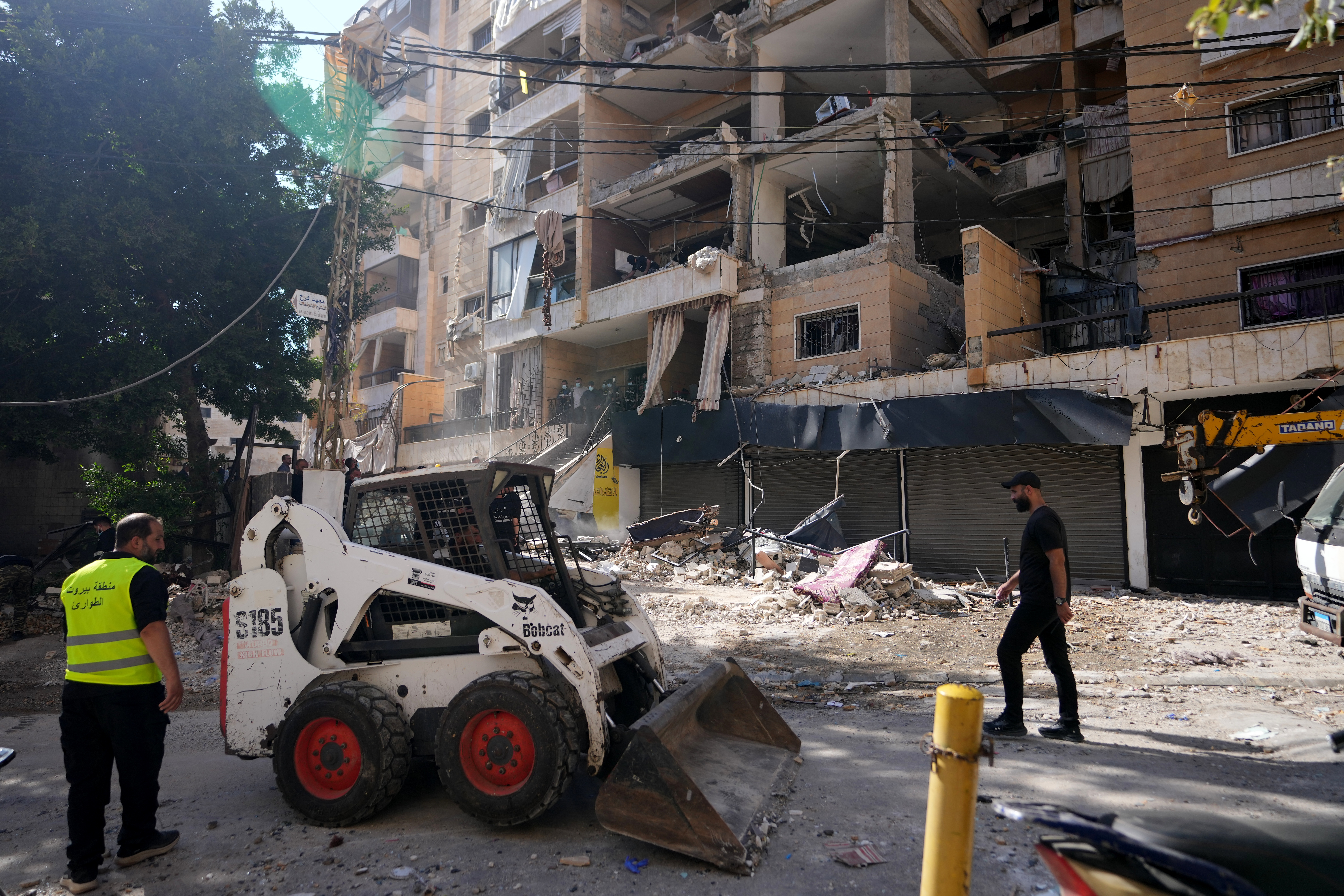 Municipality workers use a skid loader as they remove the rubble of destroyed apartments that where hit by an Israeli airstrike in Dahiyeh, Beirut's southern suburb, Lebanon, Sunday, June 7, 2026. (AP Photo/Hassan Ammar)