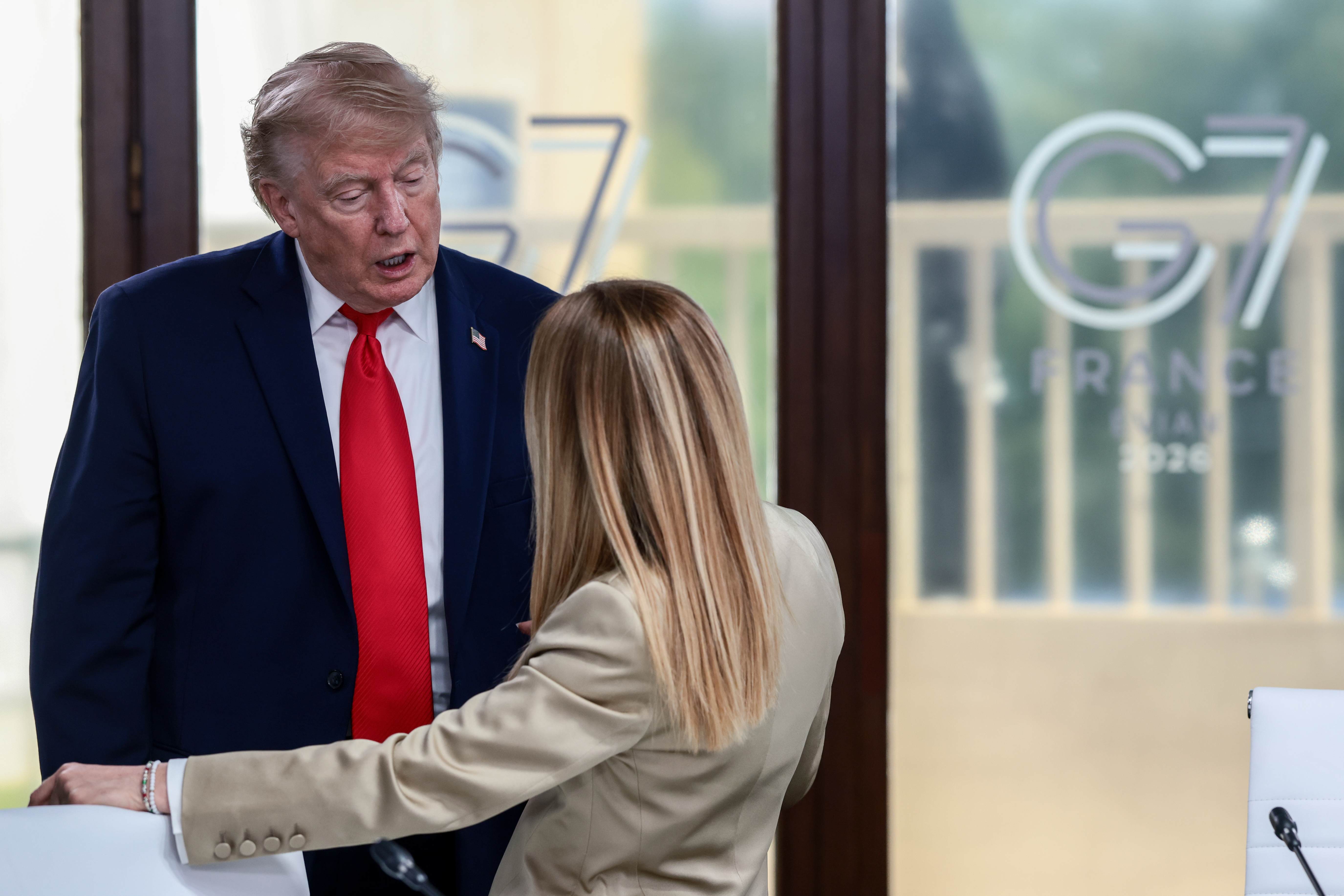 EVIAN-LES-BAINS, FRANCE - JUNE 16: U.S. President Donald Trump speaks with Italian Prime Minister Giorgia Meloni at a working lunch with leaders of G7 and the Middle East, on June 16, 2026 in Evian-les-Bains, France. Leaders from the Group of 7 (G7) countries convened in Evian, France, near the Swiss border, for their annual summit to discuss challenges to peace and security for Ukraine and Europe, the situation in the Middle East, and other geopolitical issues. (Photo by Evelyn Hockstein - Pool/Getty Images)
