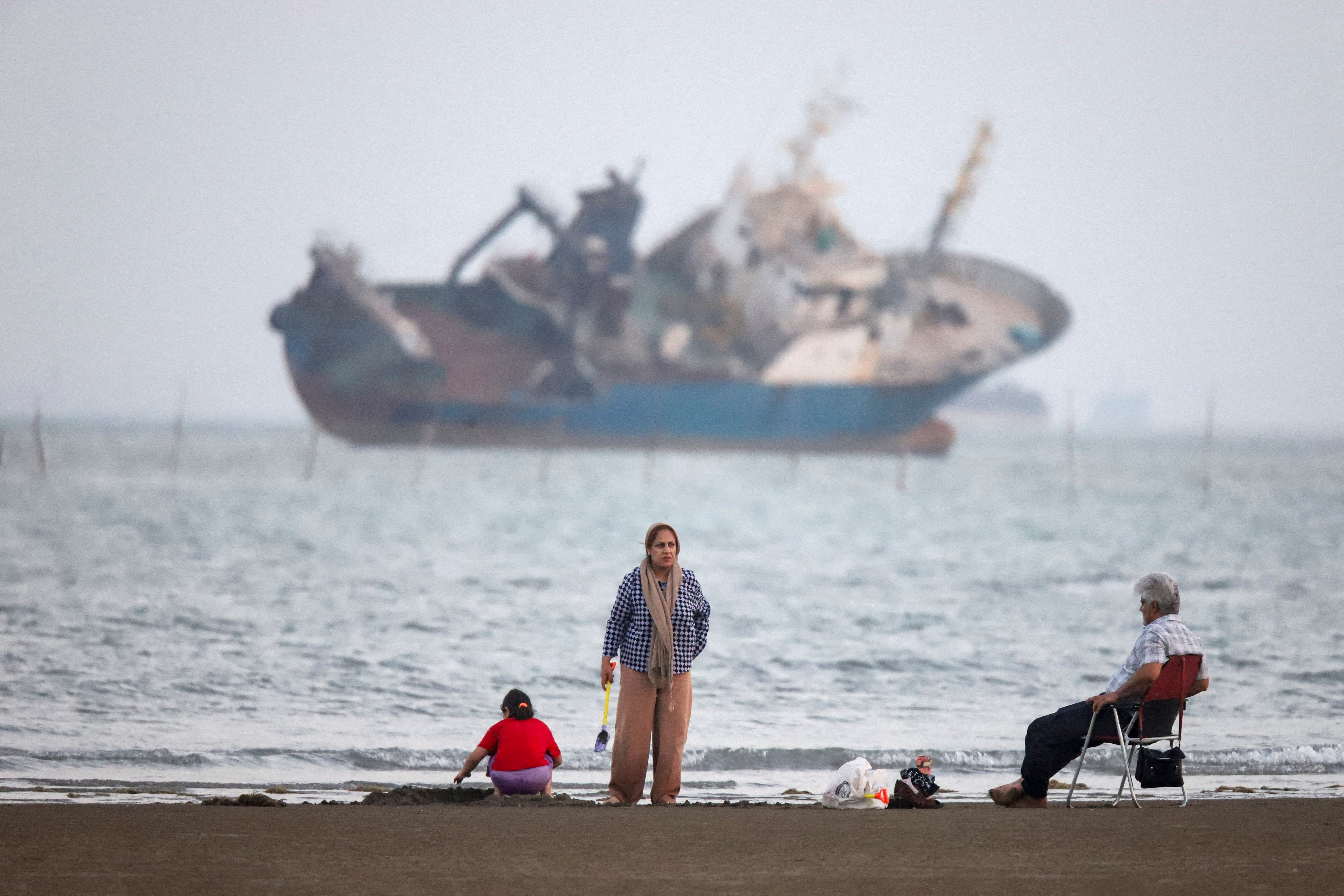 FILE PHOTO: People gather on a beach, as a vessel in the Strait of Hormuz is visible, near the beach of Bandar Abbas, Iran, May 31, 2026. Amirhosein Khorgooi/ISNA/WANA (West Asia News Agency) via REUTERS ATTENTION EDITORS - THIS PICTURE WAS PROVIDED BY A THIRD PARTY ATTENTION EDITORS - THIS PICTURE WAS PROVIDED BY A THIRD PARTY. ISRAEL OUT. NO COMMERCIAL OR EDITORIAL SALES IN ISRAEL. NO ACCESS FOR ISRAELI MEDIA. NO USE BBC PERSIAN. NO USE VOA PERSIAN. NO USE MANOTO. NO USE IRAN INTERNATIONAL. NO USE RADIO FARDA. DIGITAL: NO USE BBC PERSIAN. NO USE VOA PERSIAN. NO USE MANOTO. NO USE IRAN INTERNATIONAL. NO USE RADIO FARDA. REFILE - QUALITY REPEAT/File Photo