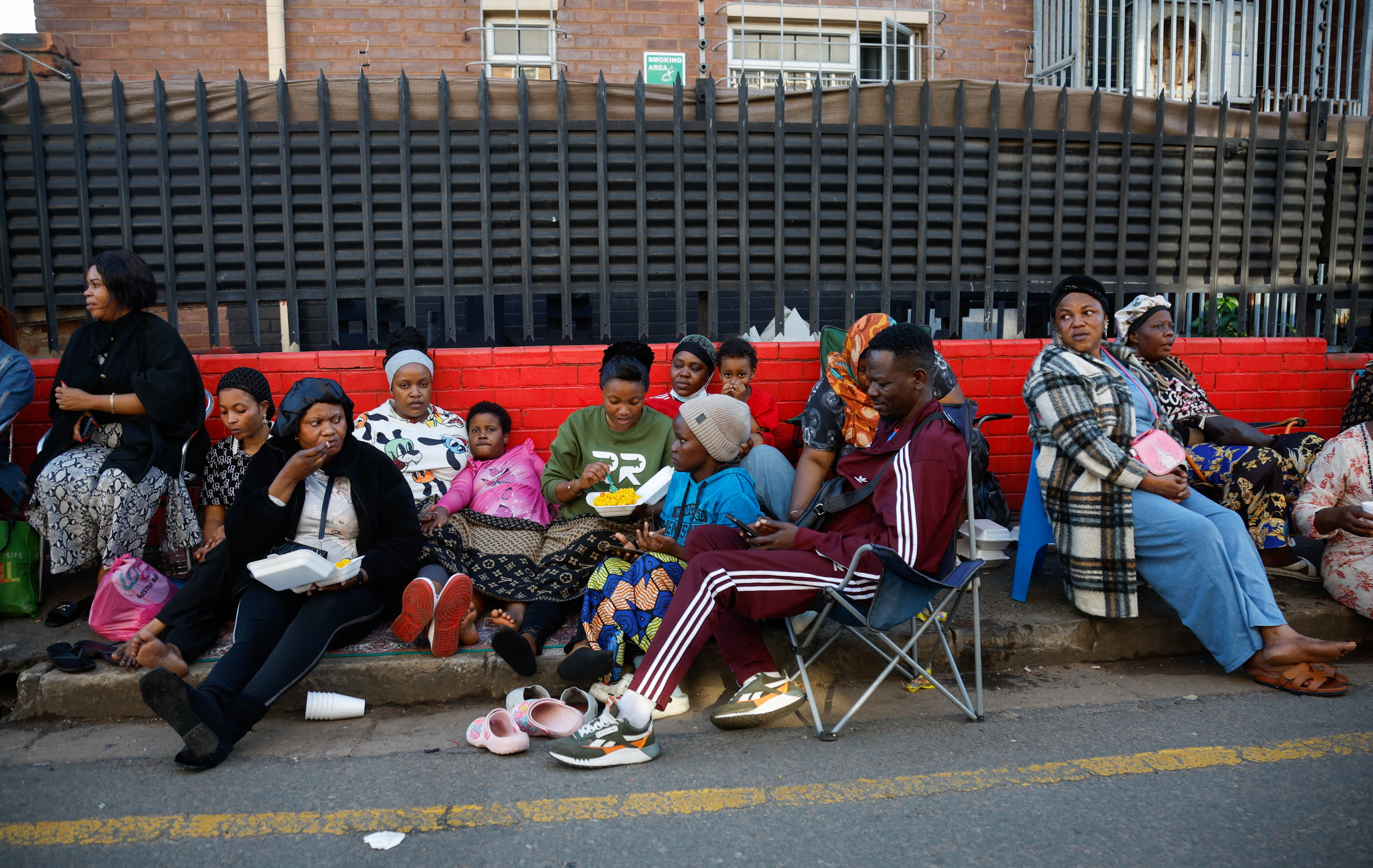 Migrants gather as rumours and warnings spread ahead of a disputed June 30 deadline [Rogan Ward/Reuters]